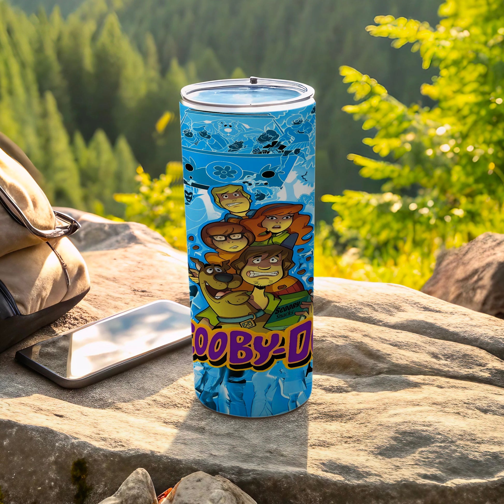 Scooby-Doo characters on a blue icy patterned tumbler with mountains in background.