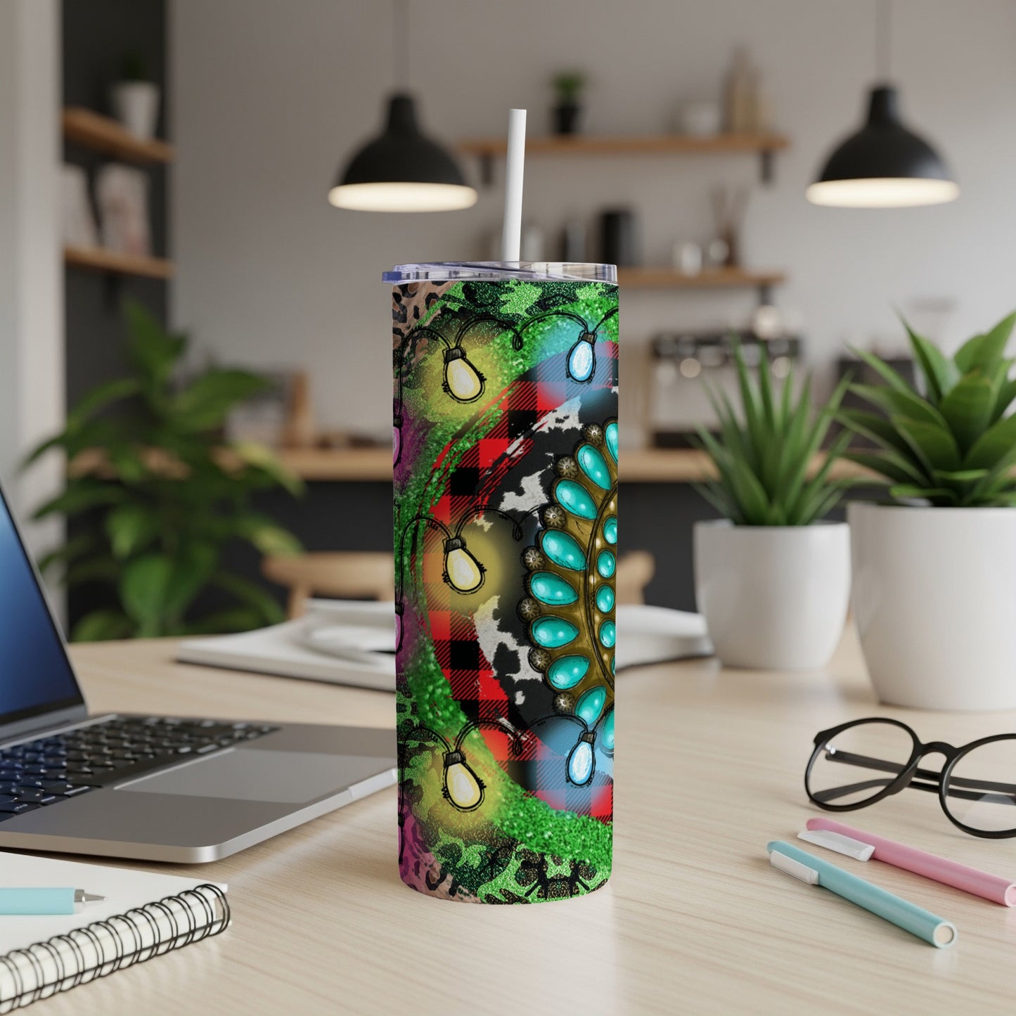 Tumbler with teal, gold, and light blue mandala design on cow print and plaid.