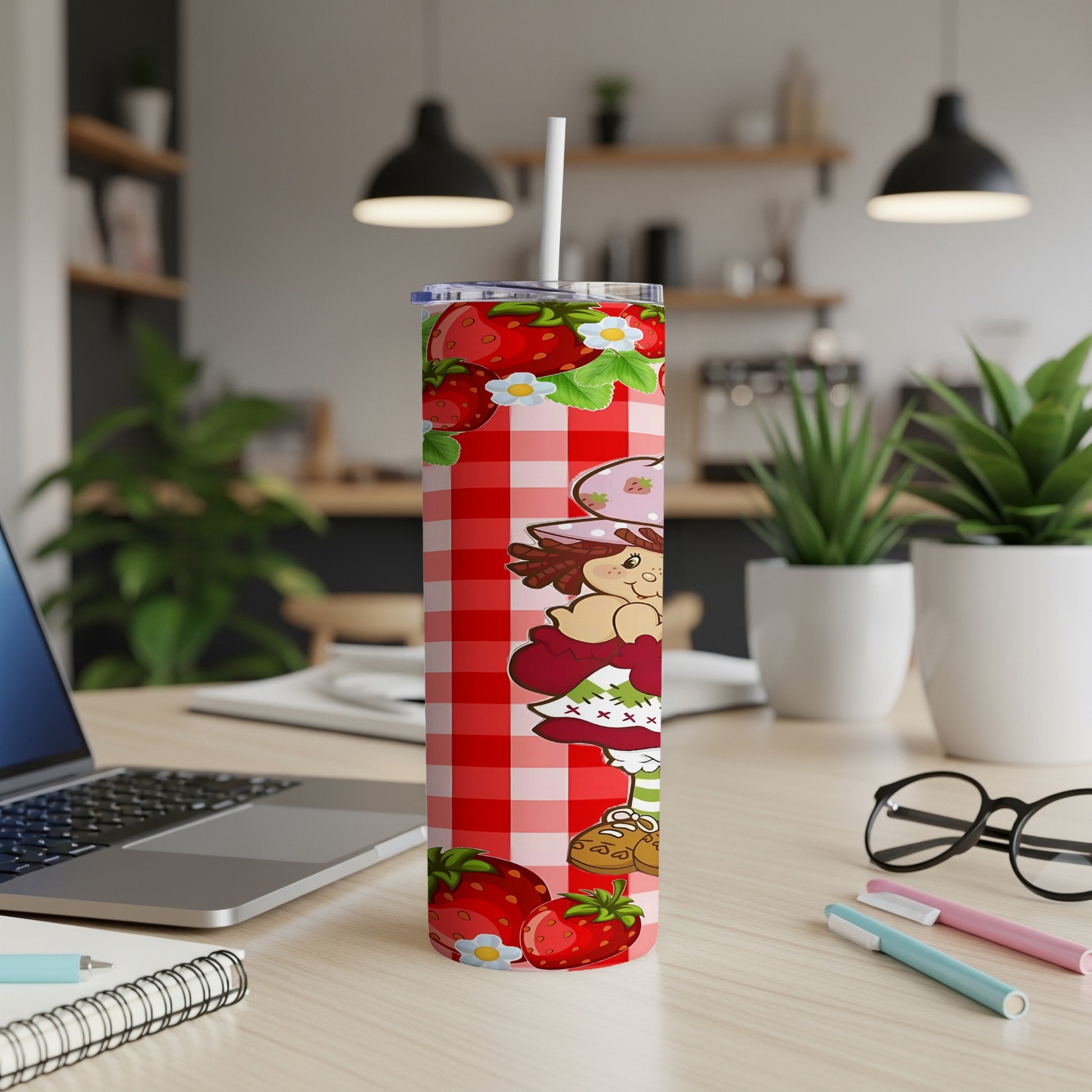 Strawberry Shortcake character on a red plaid tumbler with straw.
