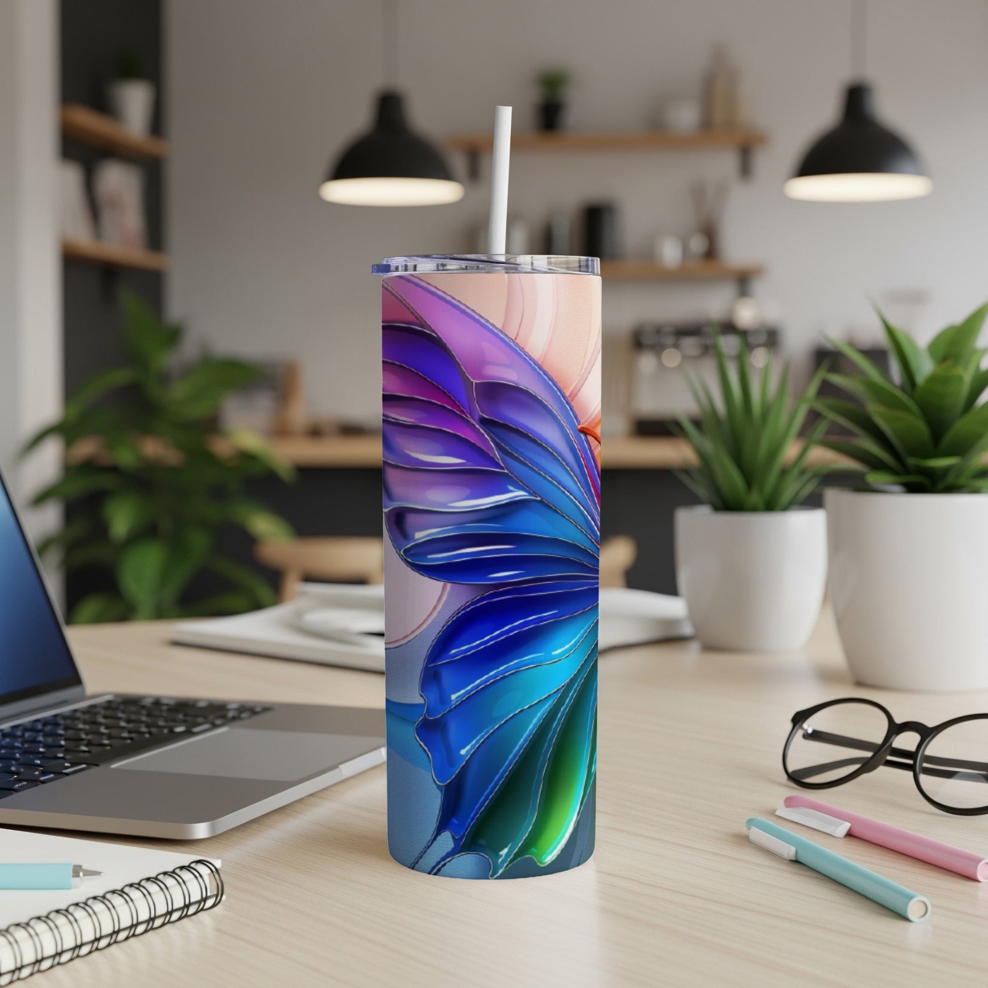 Butterfly wing pattern on a stainless steel tumbler with a straw.