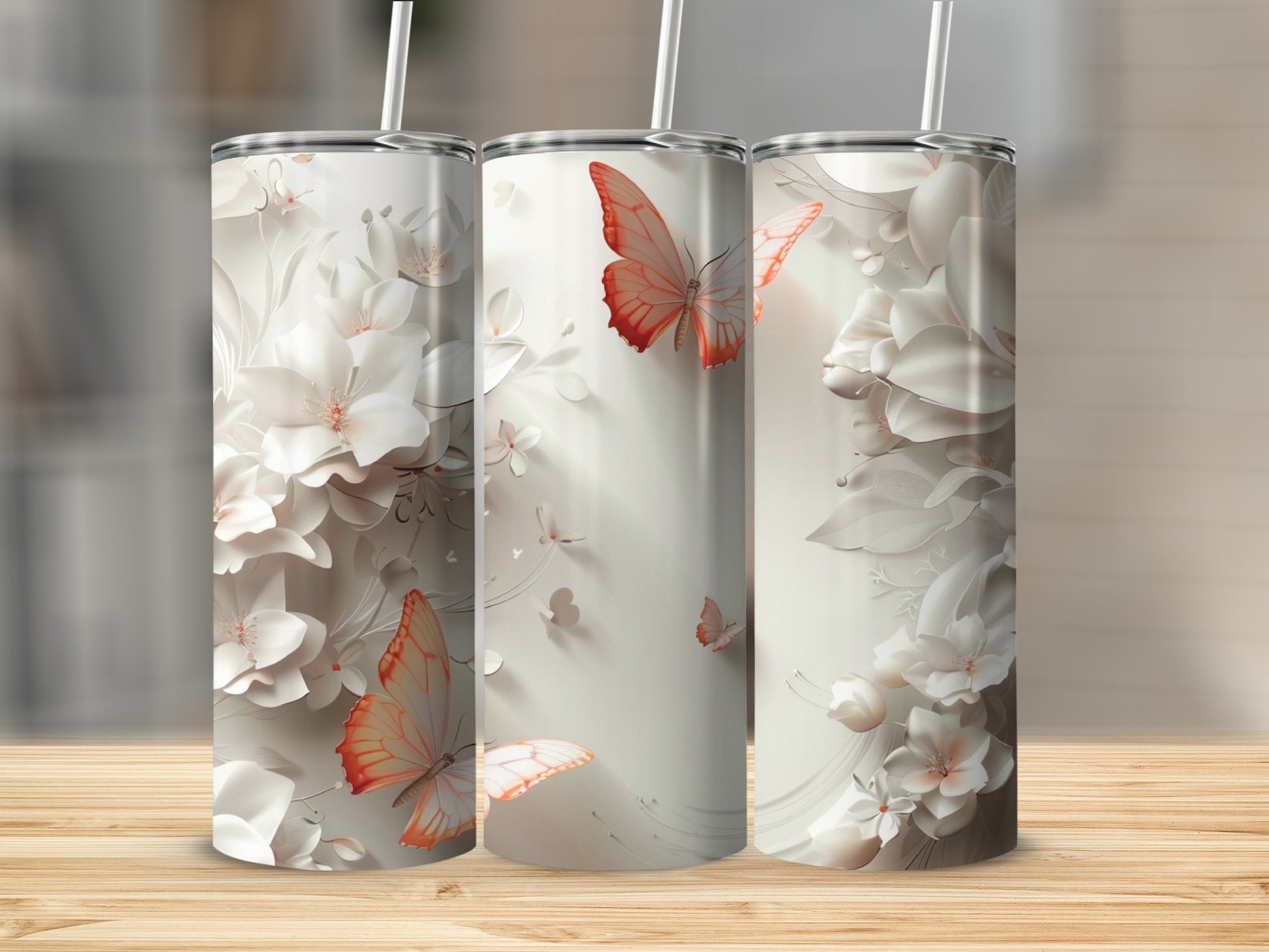 Three white tumblers with embossed floral and butterfly designs.