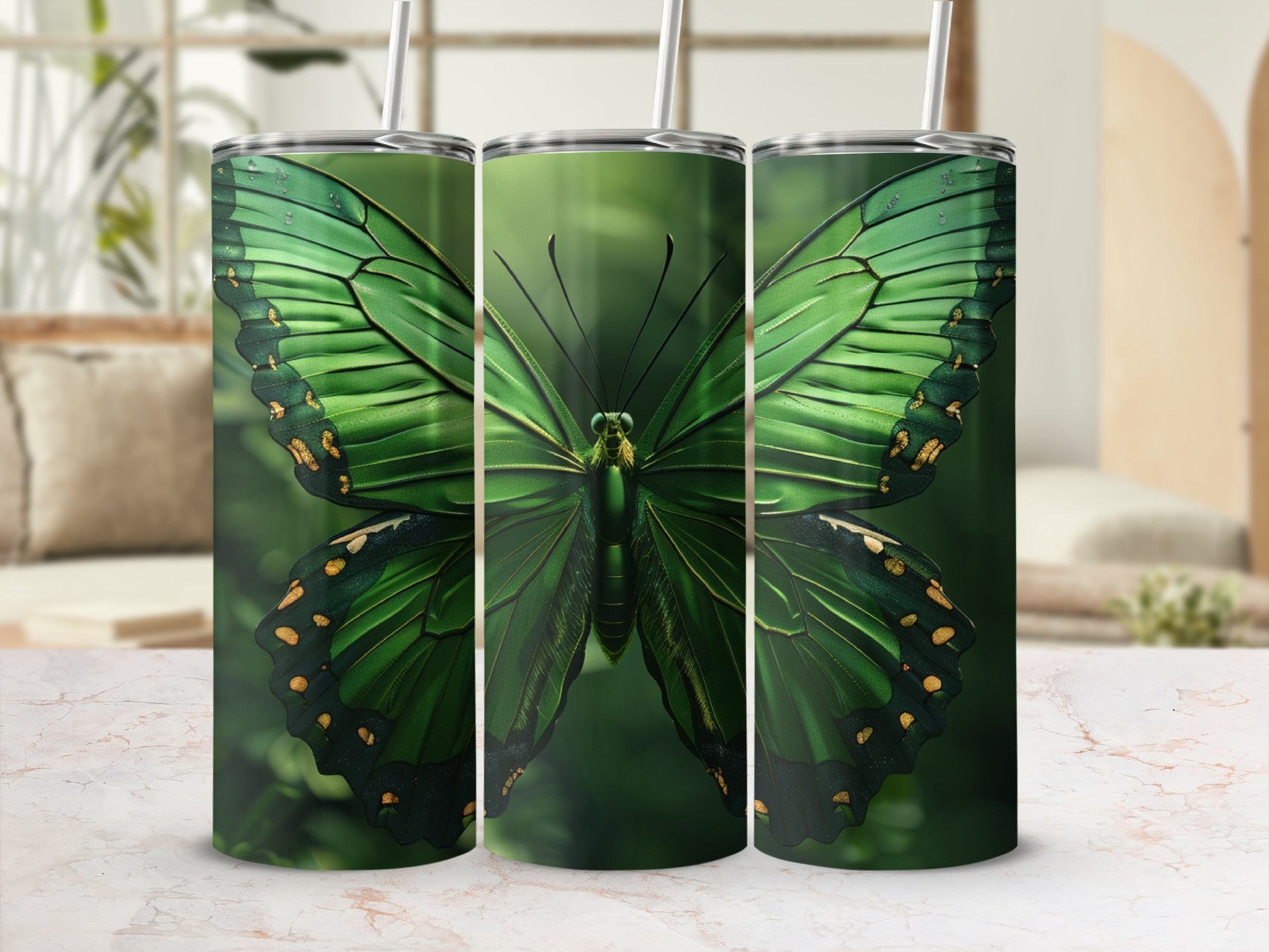 Green butterfly design on a set of three stainless steel tumblers.