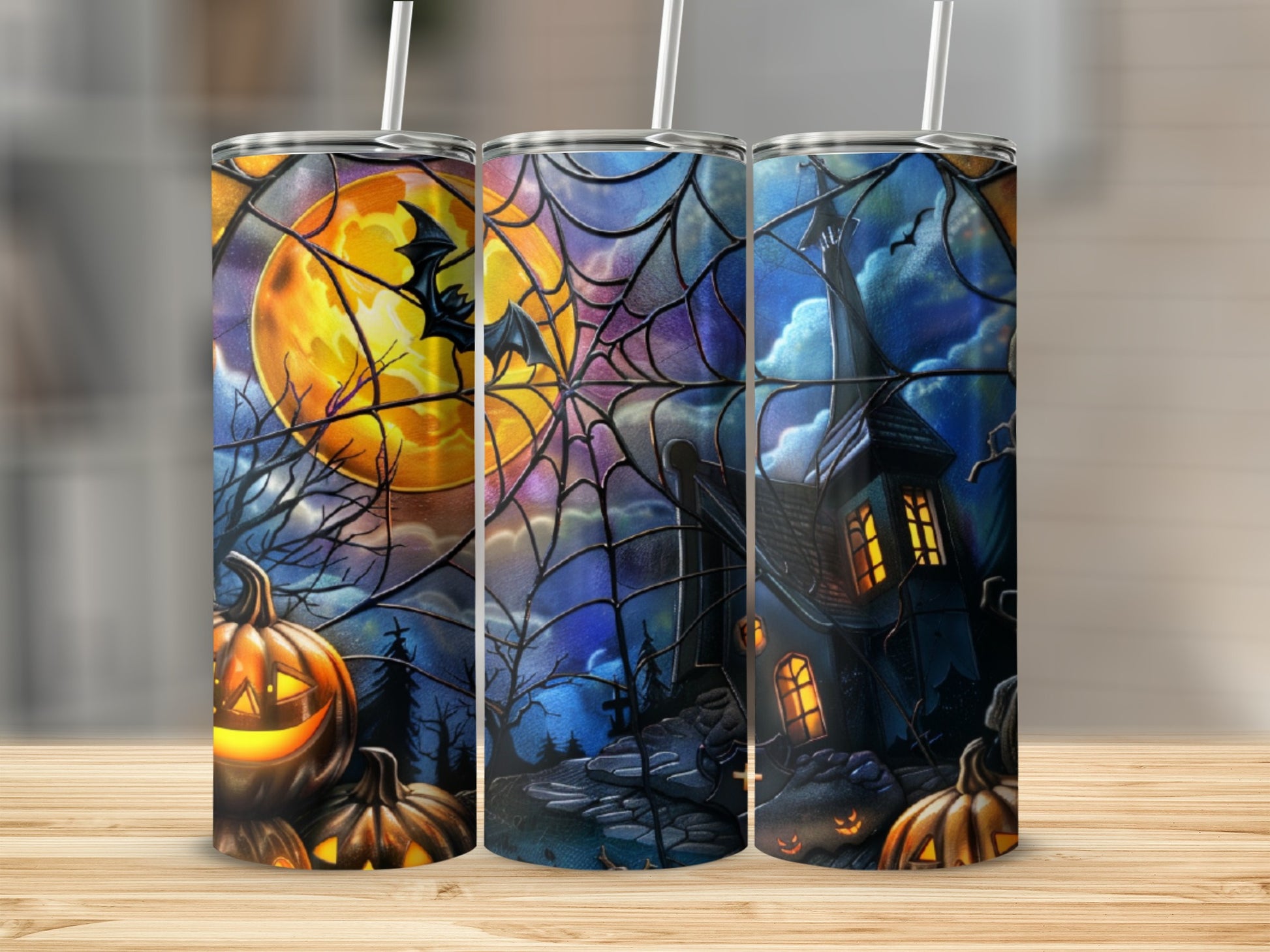 Halloween tumbler with haunted house, pumpkins, and bats on spiderweb background.