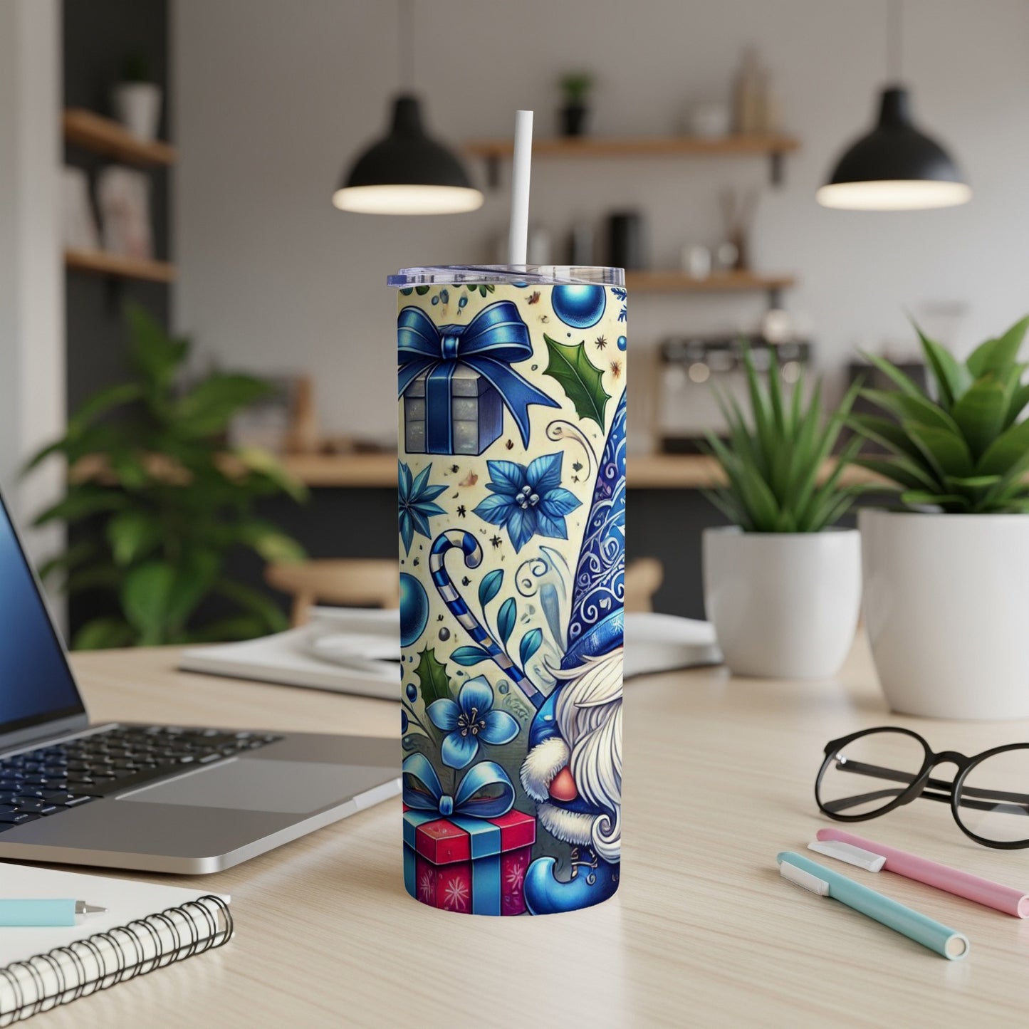 Blue and white gnome and Christmas pattern tumbler with straw on desk.