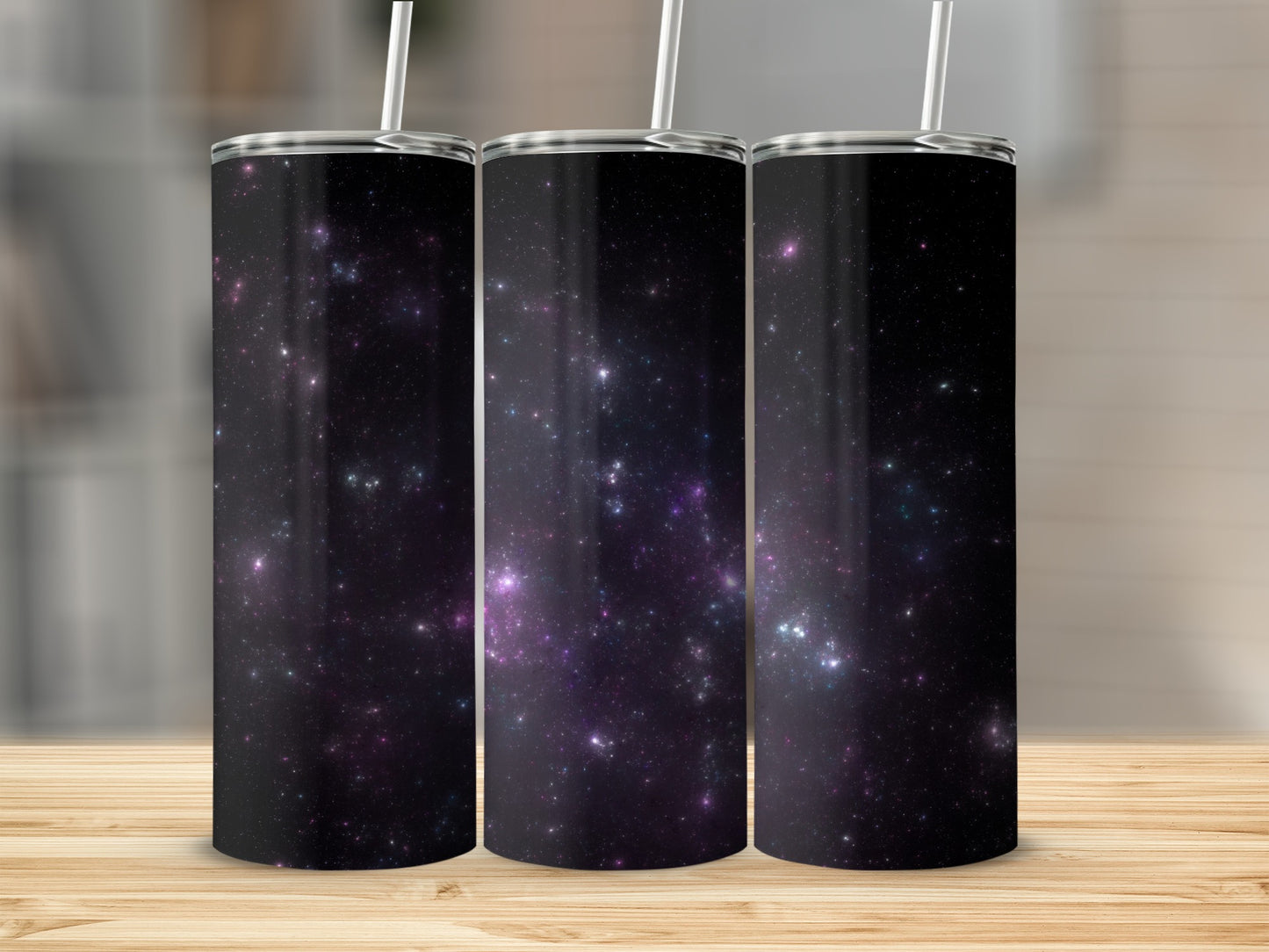 Three tumblers with a dark space nebula design and straws.