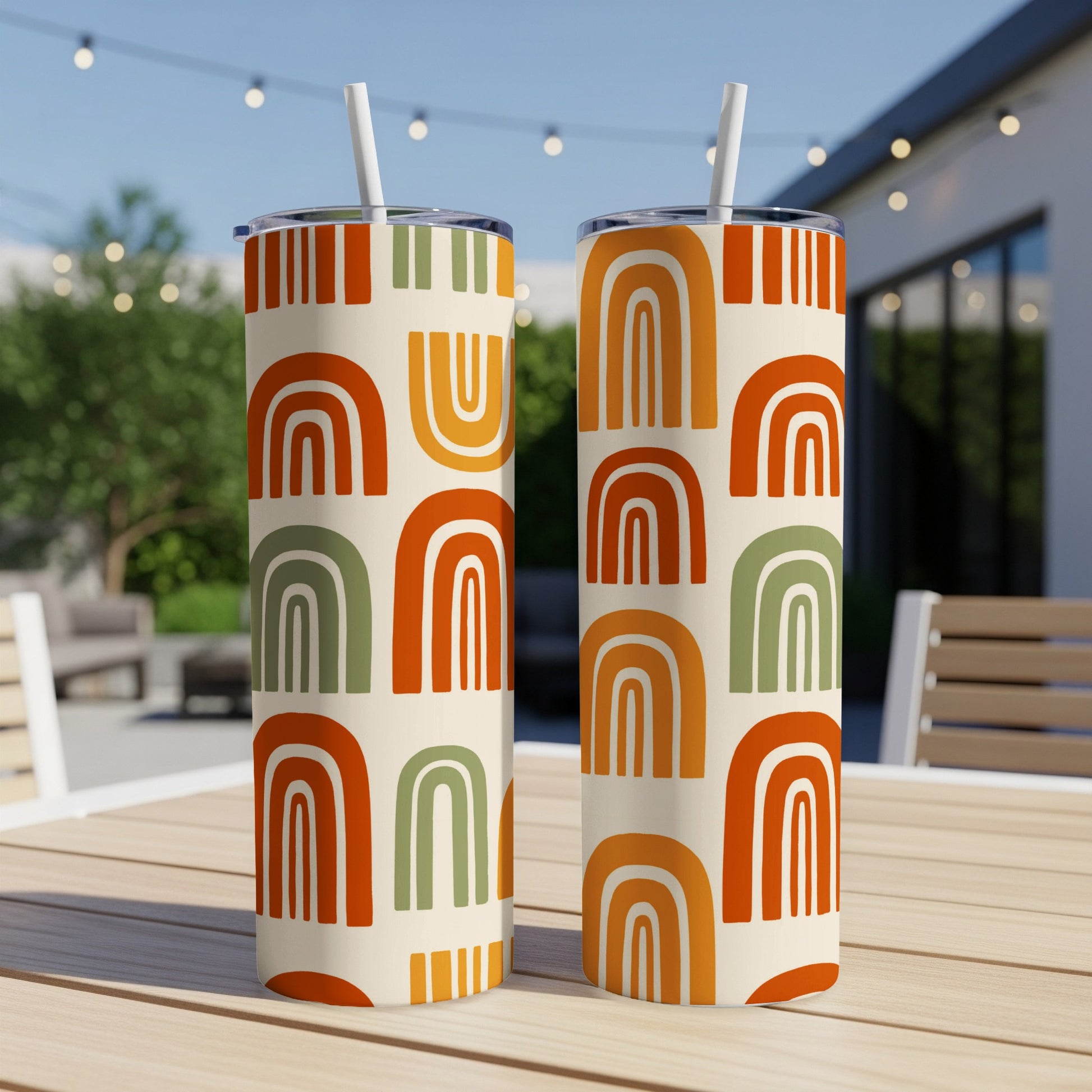 Two tumblers with mid-century modern rainbow and stripe patterns.