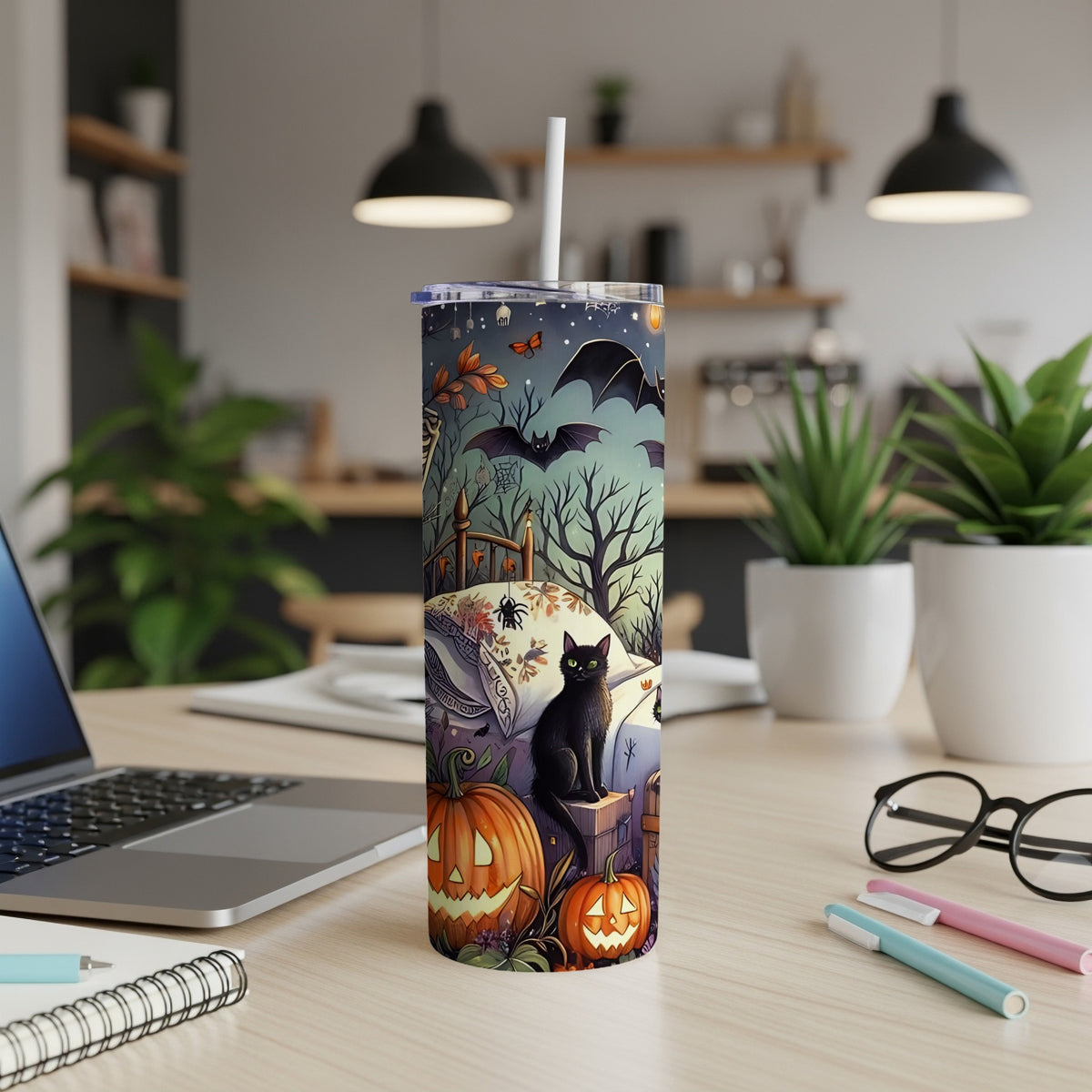 Black cat with pumpkins and bats on a Halloween-themed tumbler.