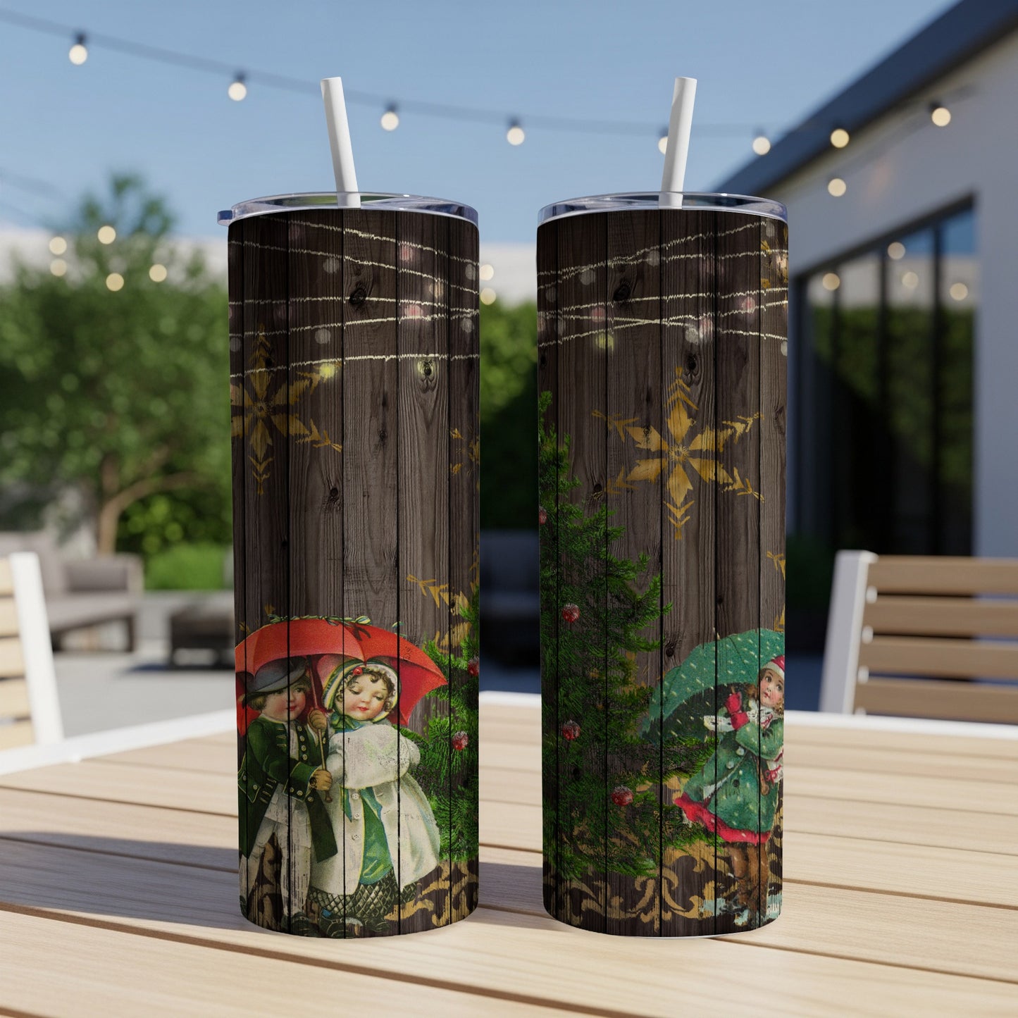 Two tall tumblers with vintage Christmas children and snowflakes on wood background.