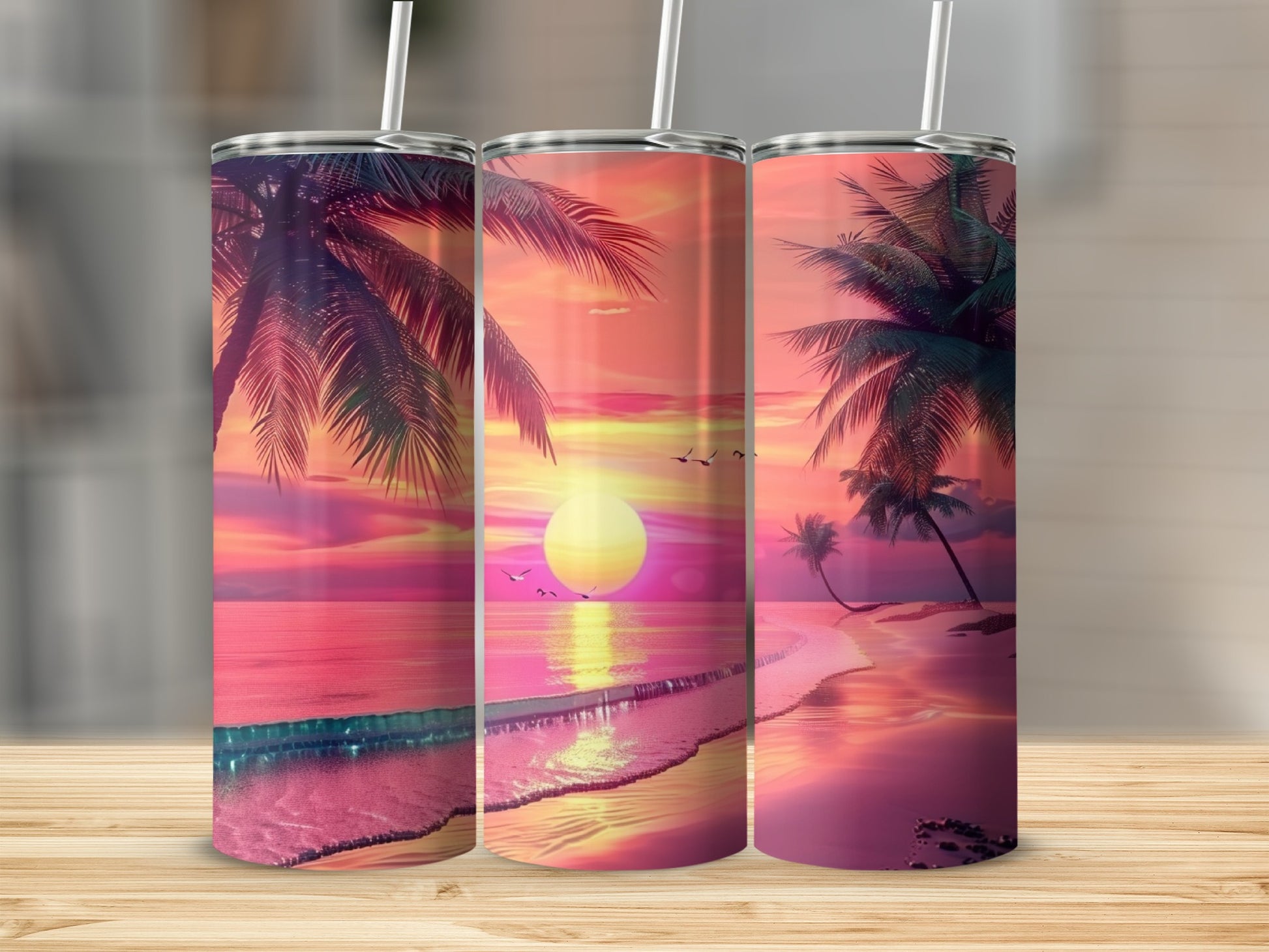 Three tumblers featuring a vibrant sunset over a tropical beach with palm trees.