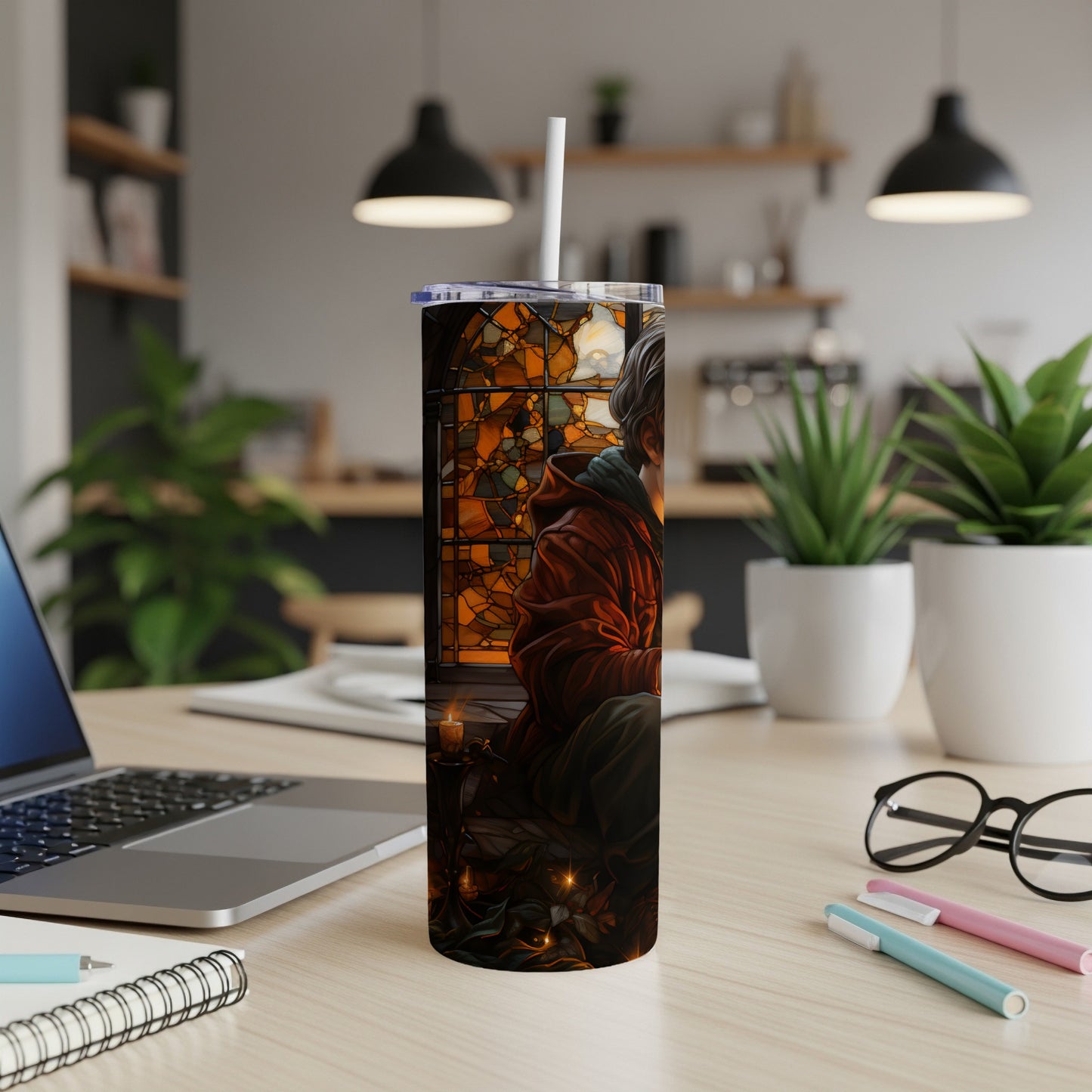 Illuminated tumbler with fantasy art of a cloaked figure and stained glass.