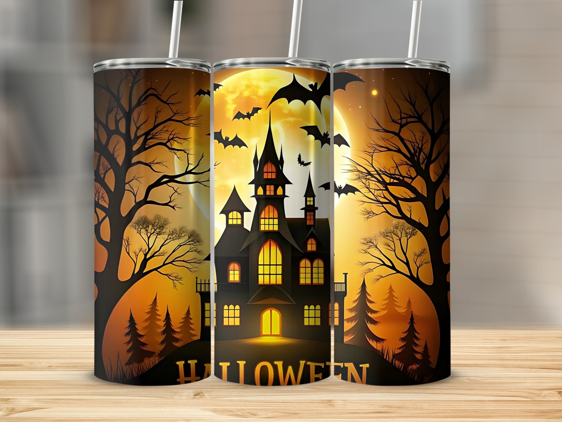 Three tumblers display a Halloween scene with a haunted house, full moon, bats, and trees.