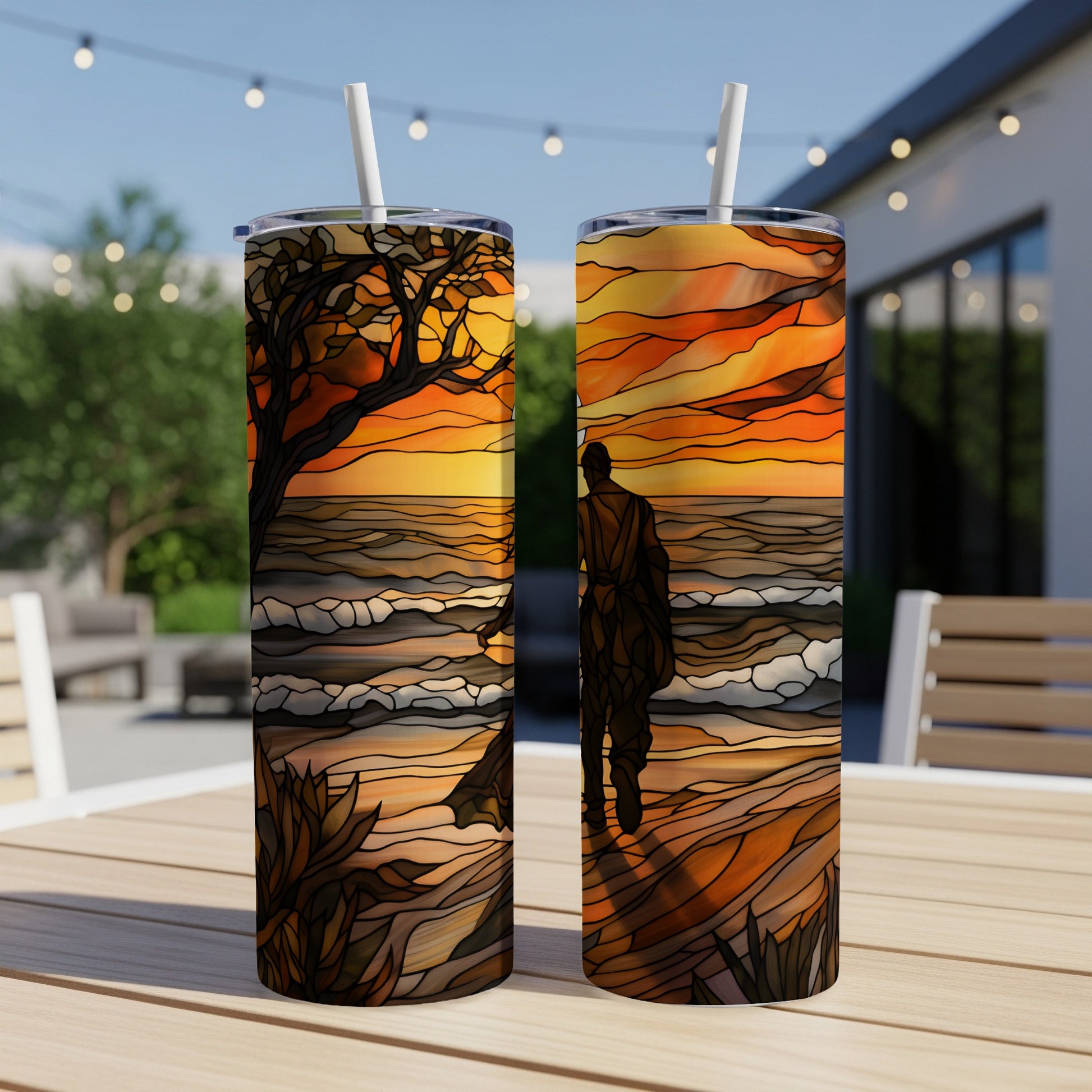 Stained glass artwork depicting a person walking on a beach at sunset.