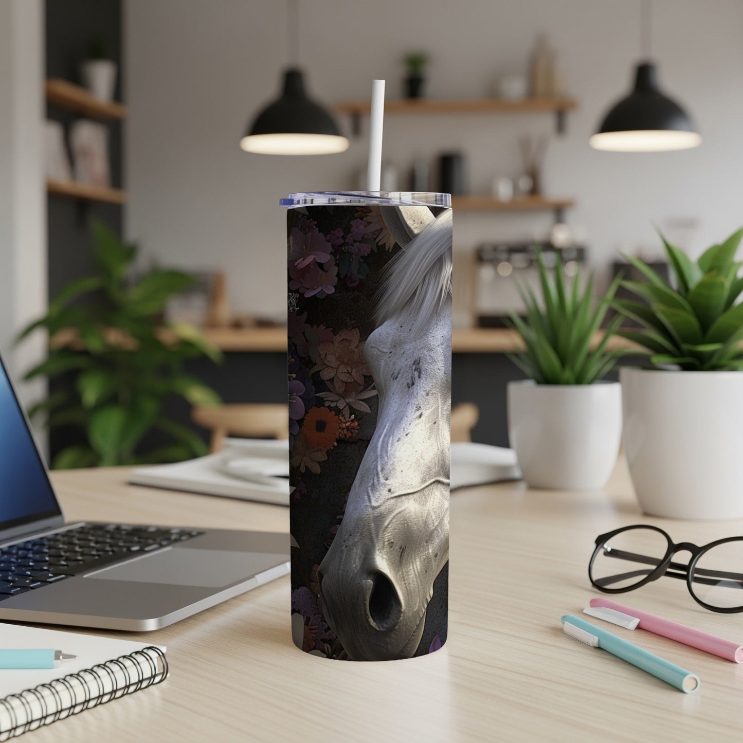 White horse head profile on floral background, on a tumbler on a desk.