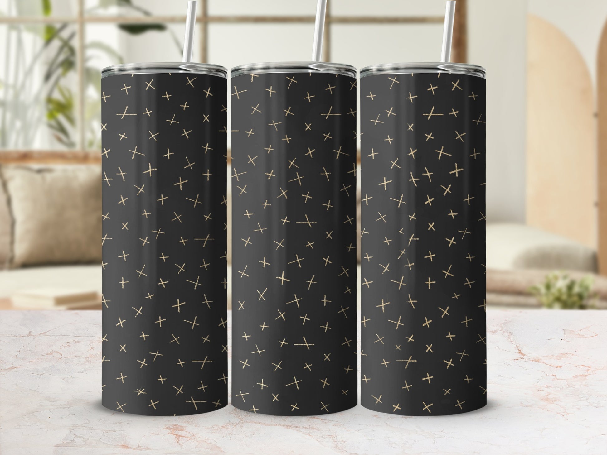 Three black tumblers with a scattered gold plus sign pattern and silver straws.