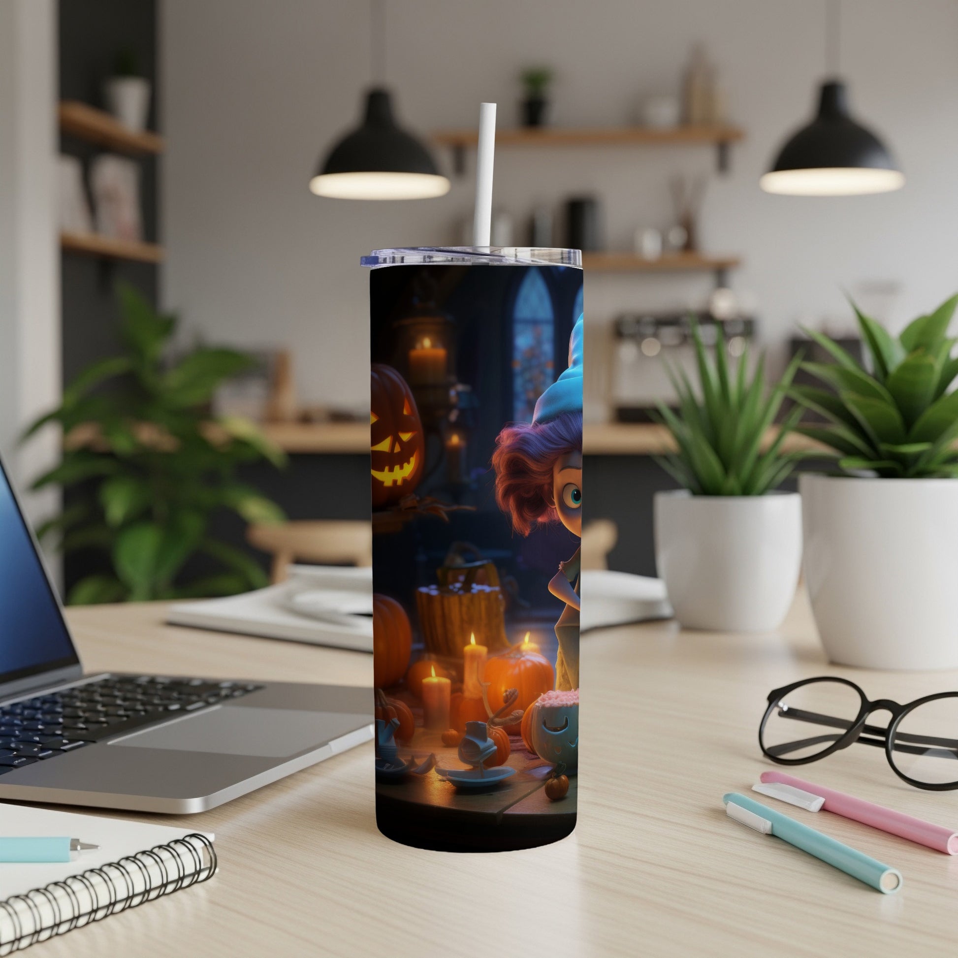 Tall tumbler with a Halloween cartoon witch and pumpkins on a desk.