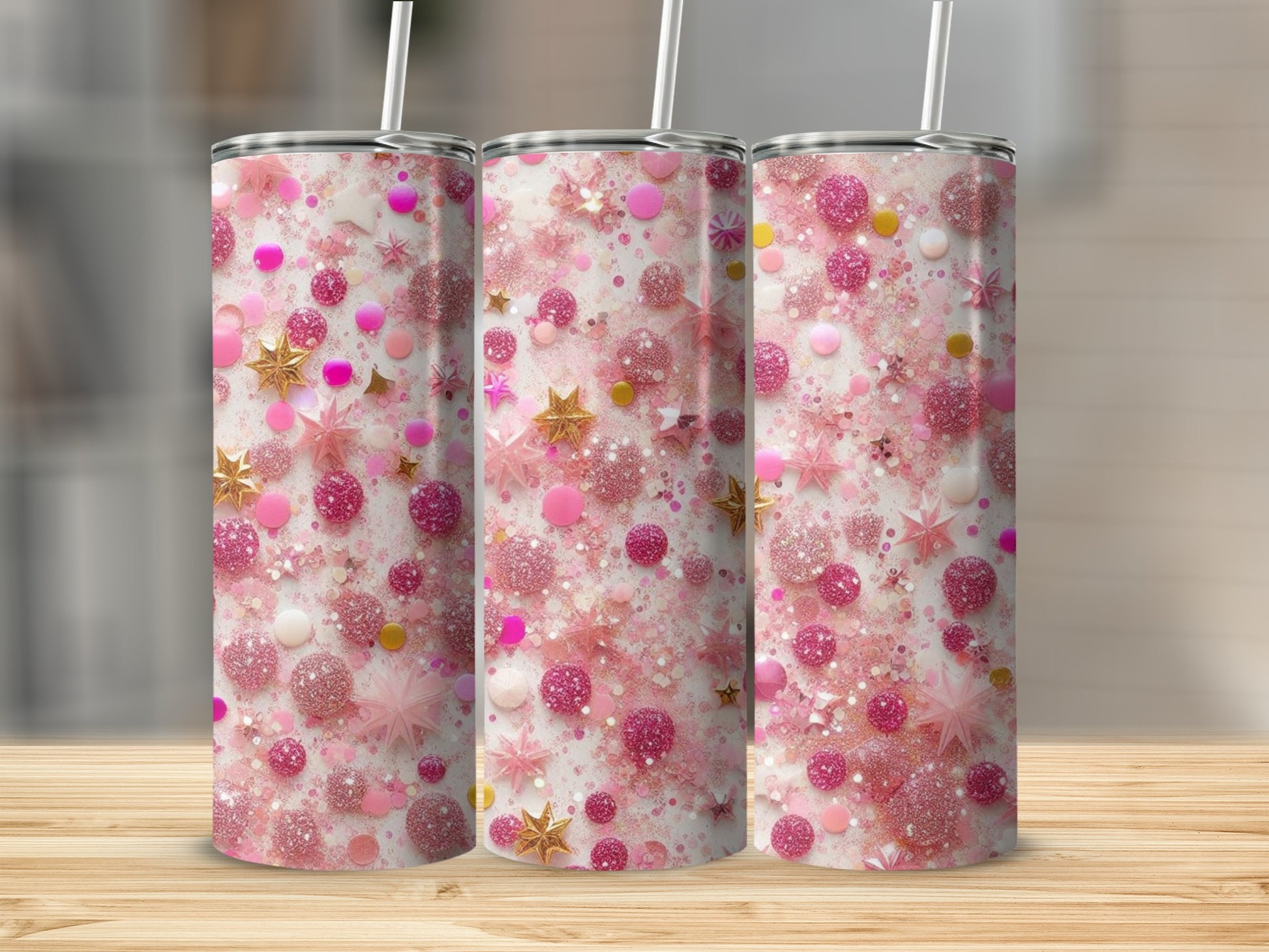 Three glittery pink tumblers with star and bubble patterns on a wooden surface.