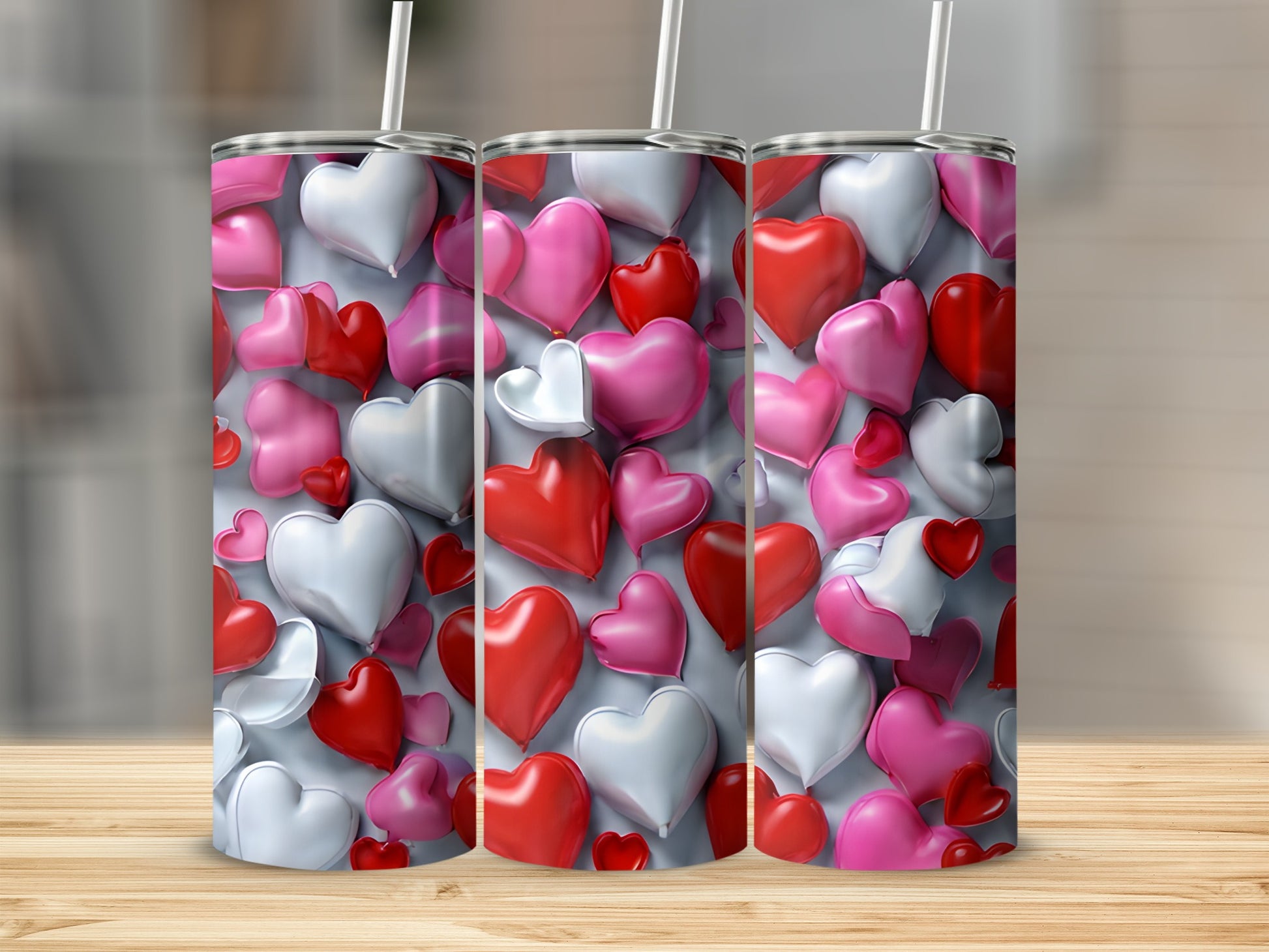Three cylindrical tumblers with a heart pattern.