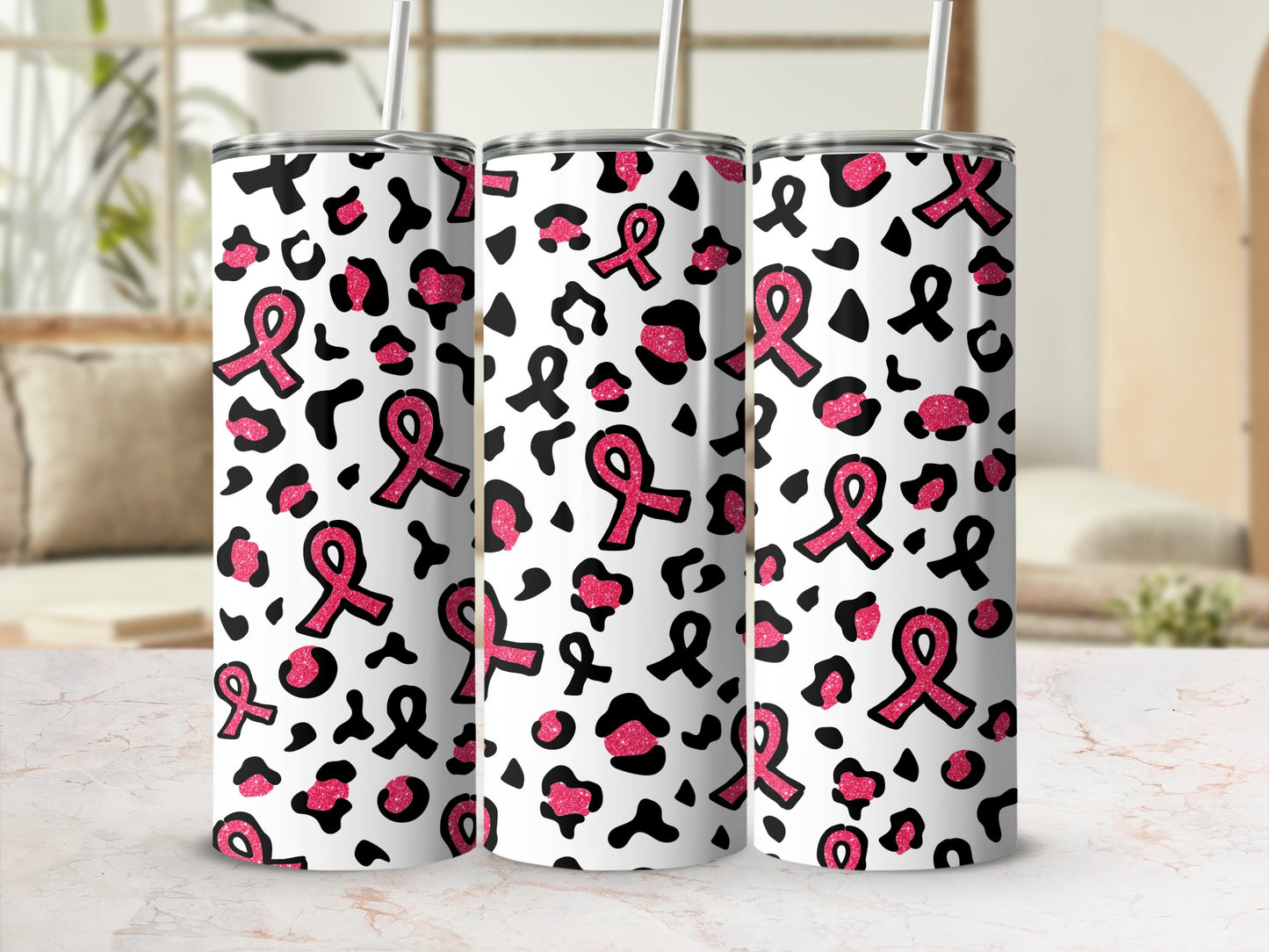 Pink breast cancer ribbons and leopard spots on three tumblers.