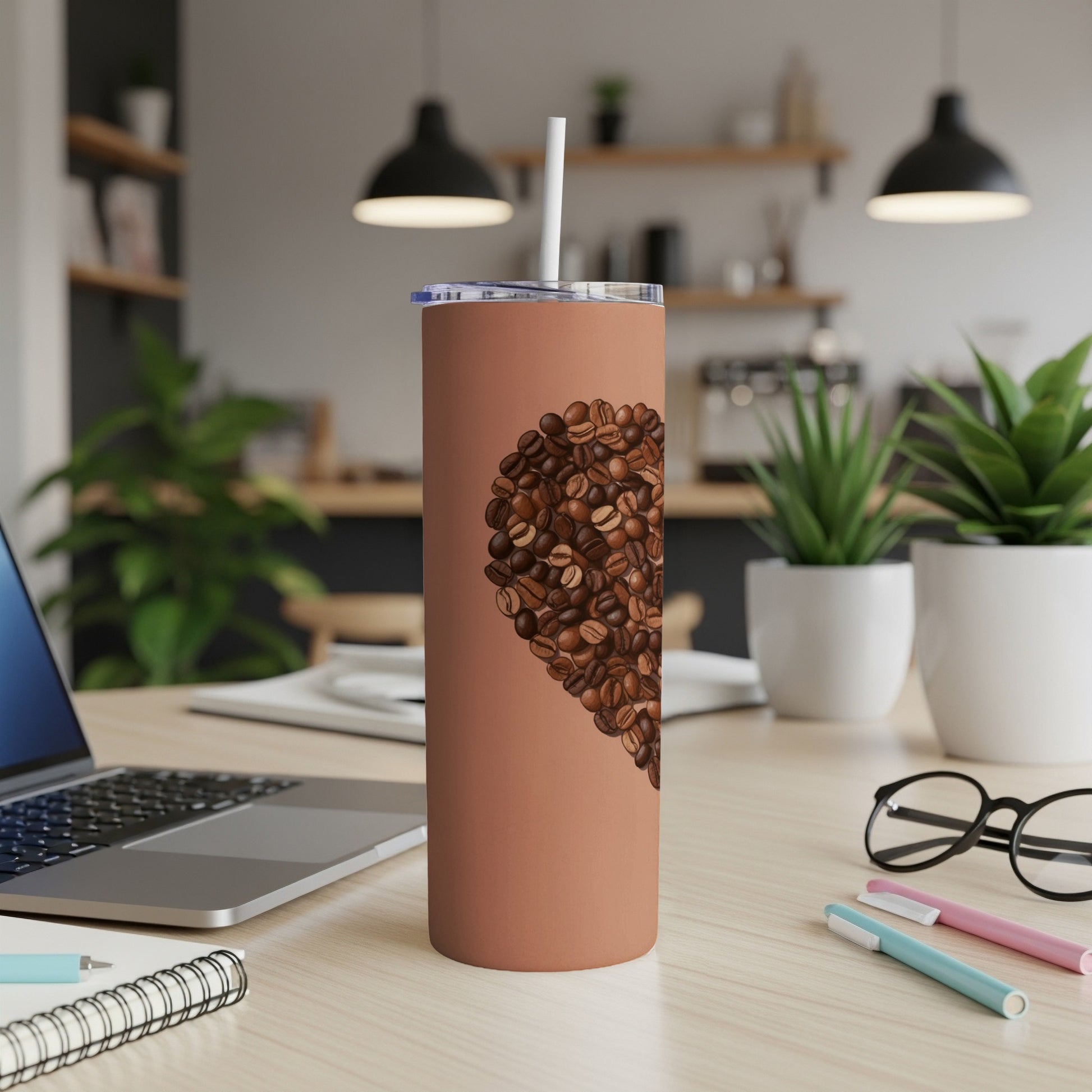 Brown tumbler with heart shape made of coffee beans.