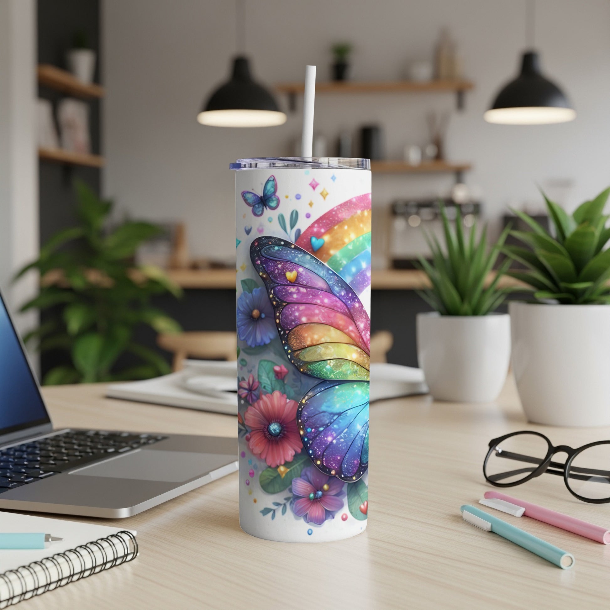 Rainbow butterfly and floral patterned tumbler with straw.