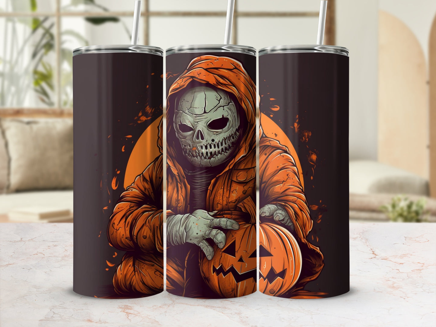 Three tumblers with a Halloween skeleton in an orange hoodie holding a jack-o'-lantern.