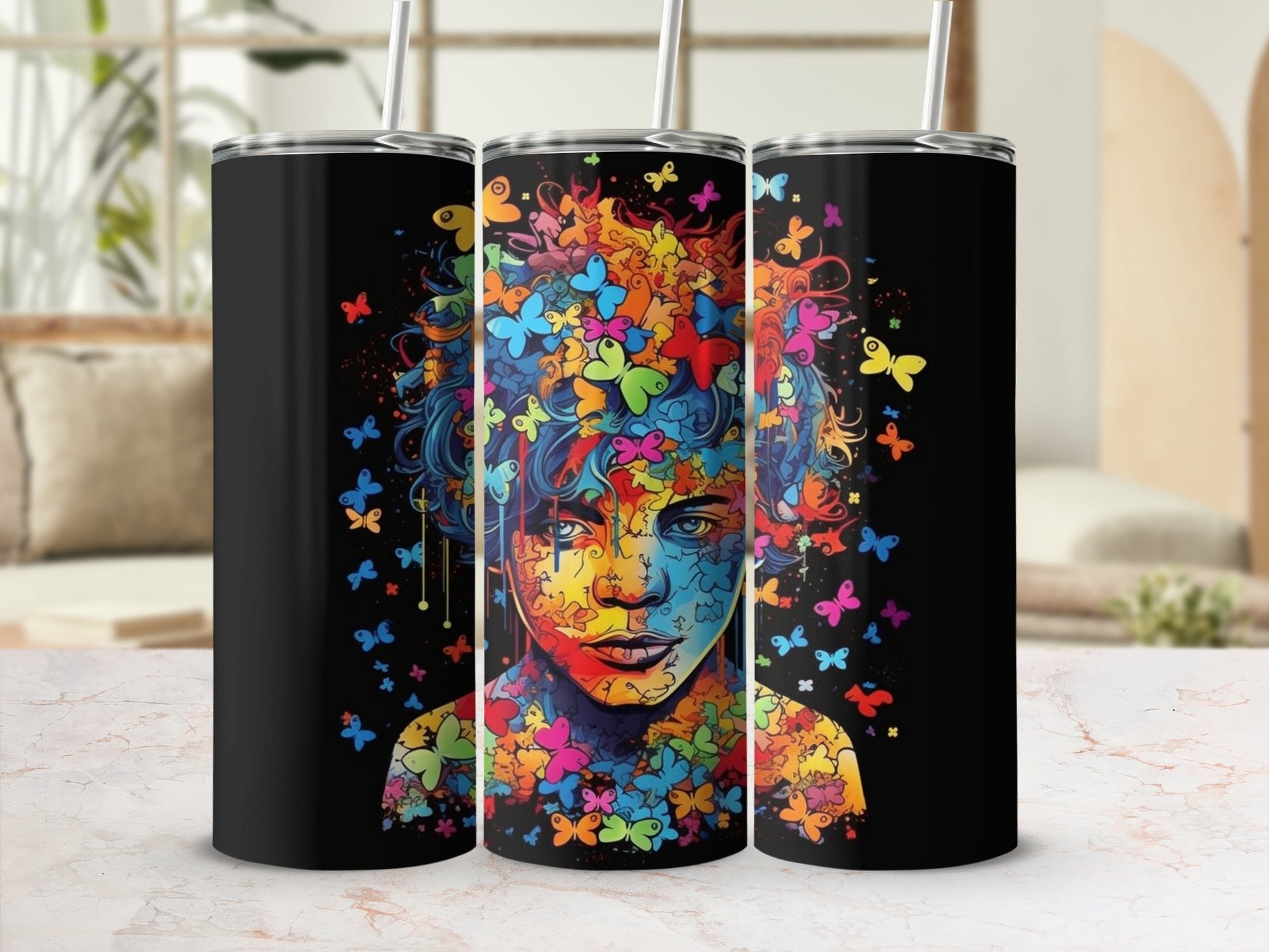 Tumbler featuring a colorful portrait of a person surrounded by abstract butterflies.