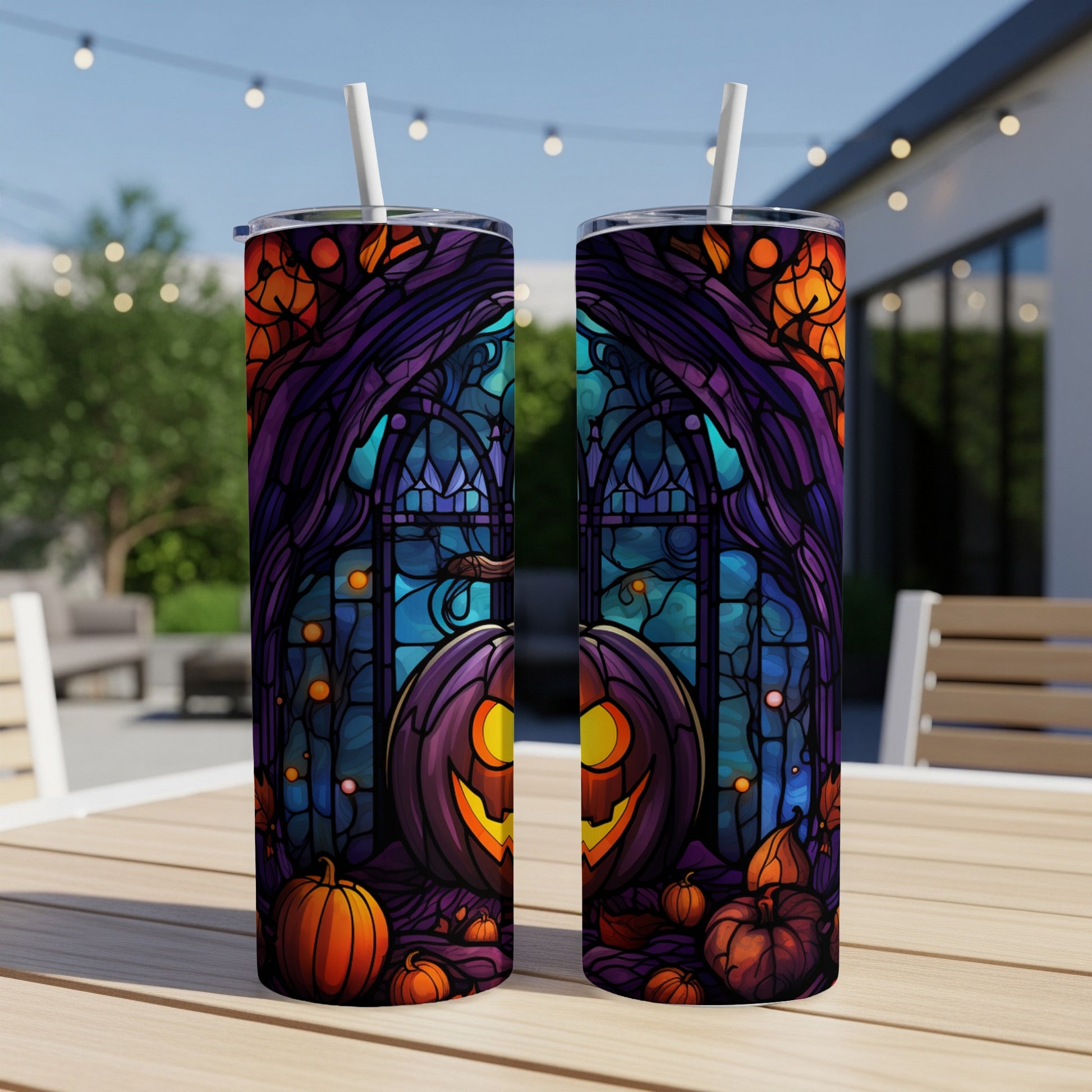 Two tumblers featuring stained glass pumpkins and Halloween motifs.