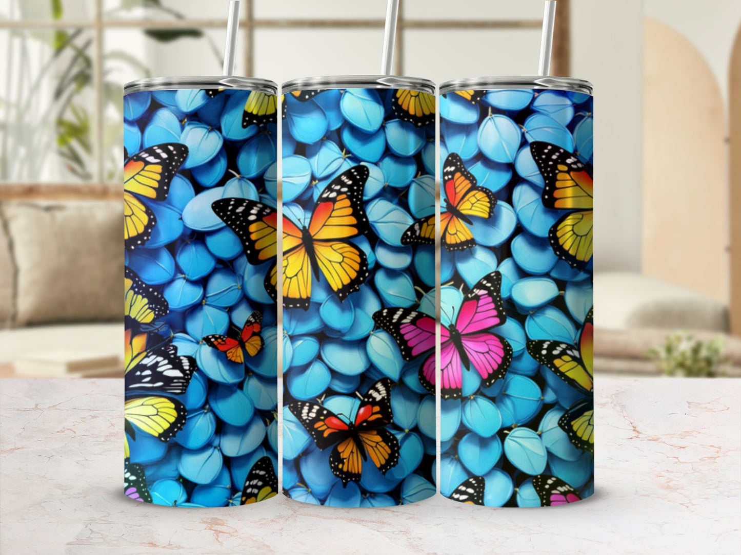 Three tumblers with a vibrant butterfly and blue pebble pattern.