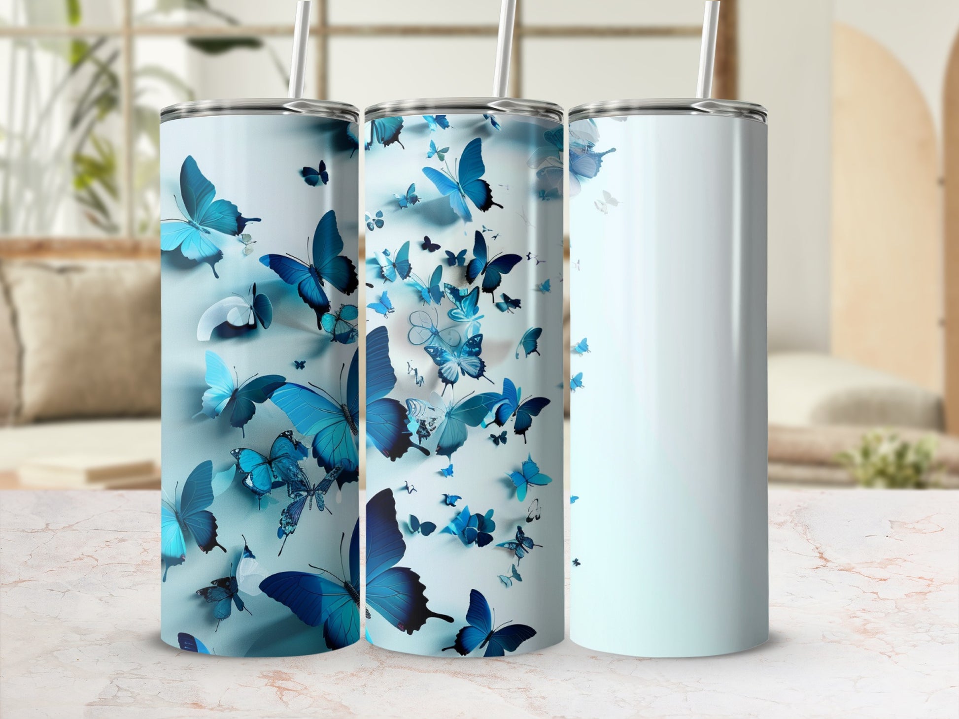 Three tumblers with a pattern of blue butterflies on a light background.