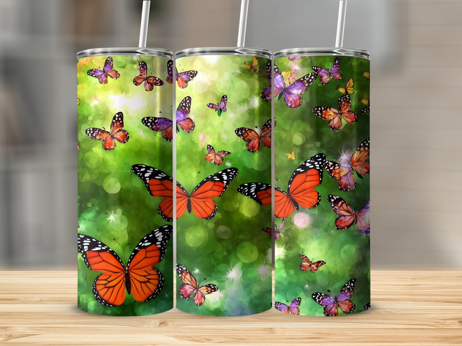 Three tumblers with colorful butterflies and bokeh light effects.