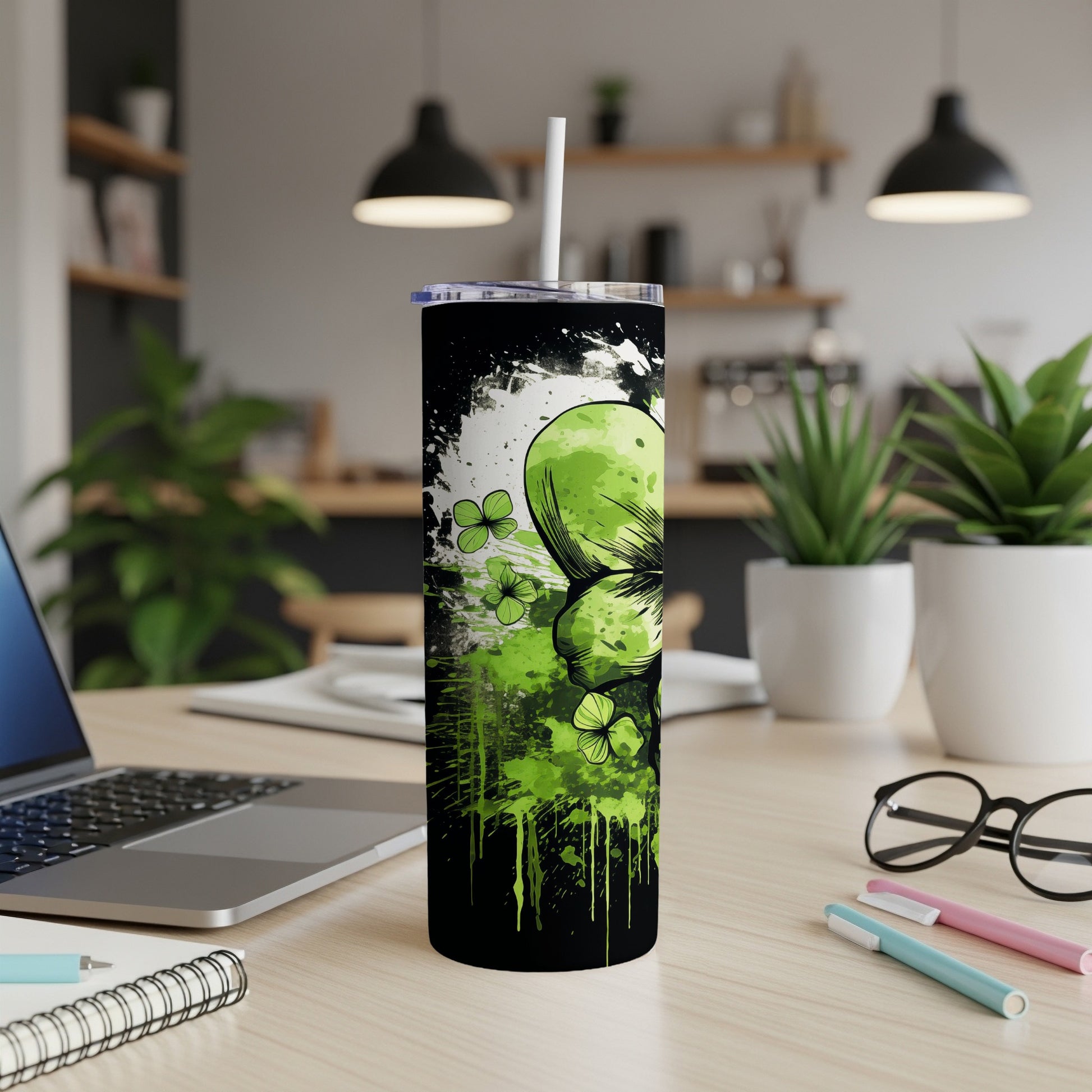 Black tumbler with green shamrock and splatter paint design.