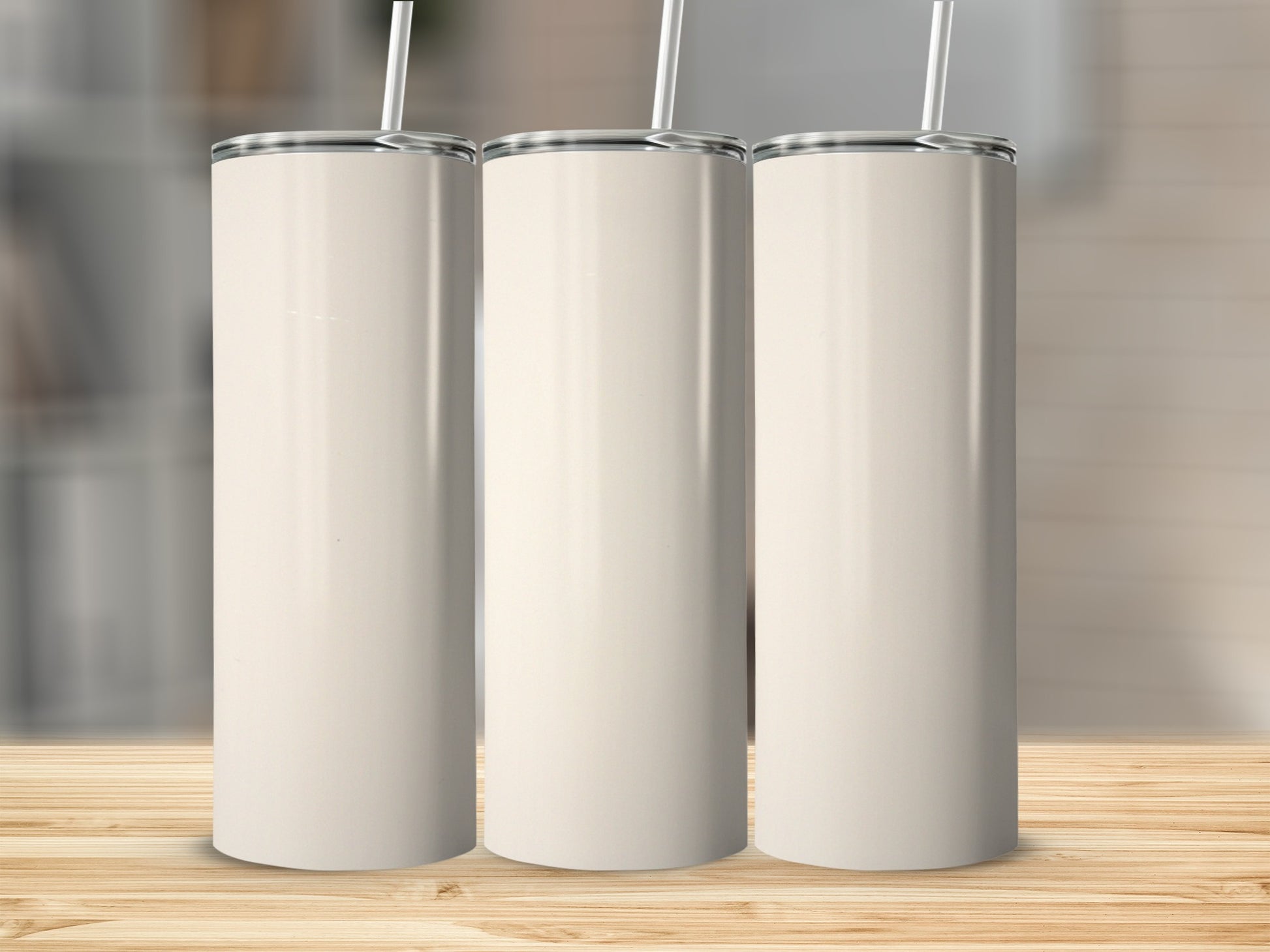 Three plain, tall, white tumblers with straws stand on a wooden surface.