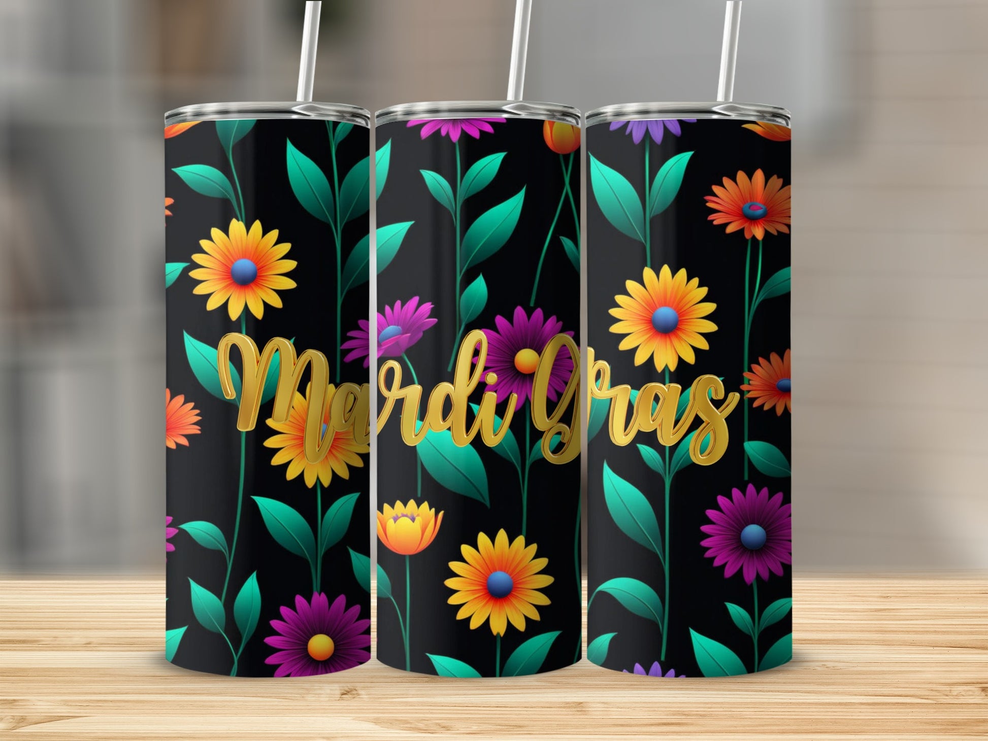 Three Mardi Gras tumblers with floral designs stand on a wooden surface.