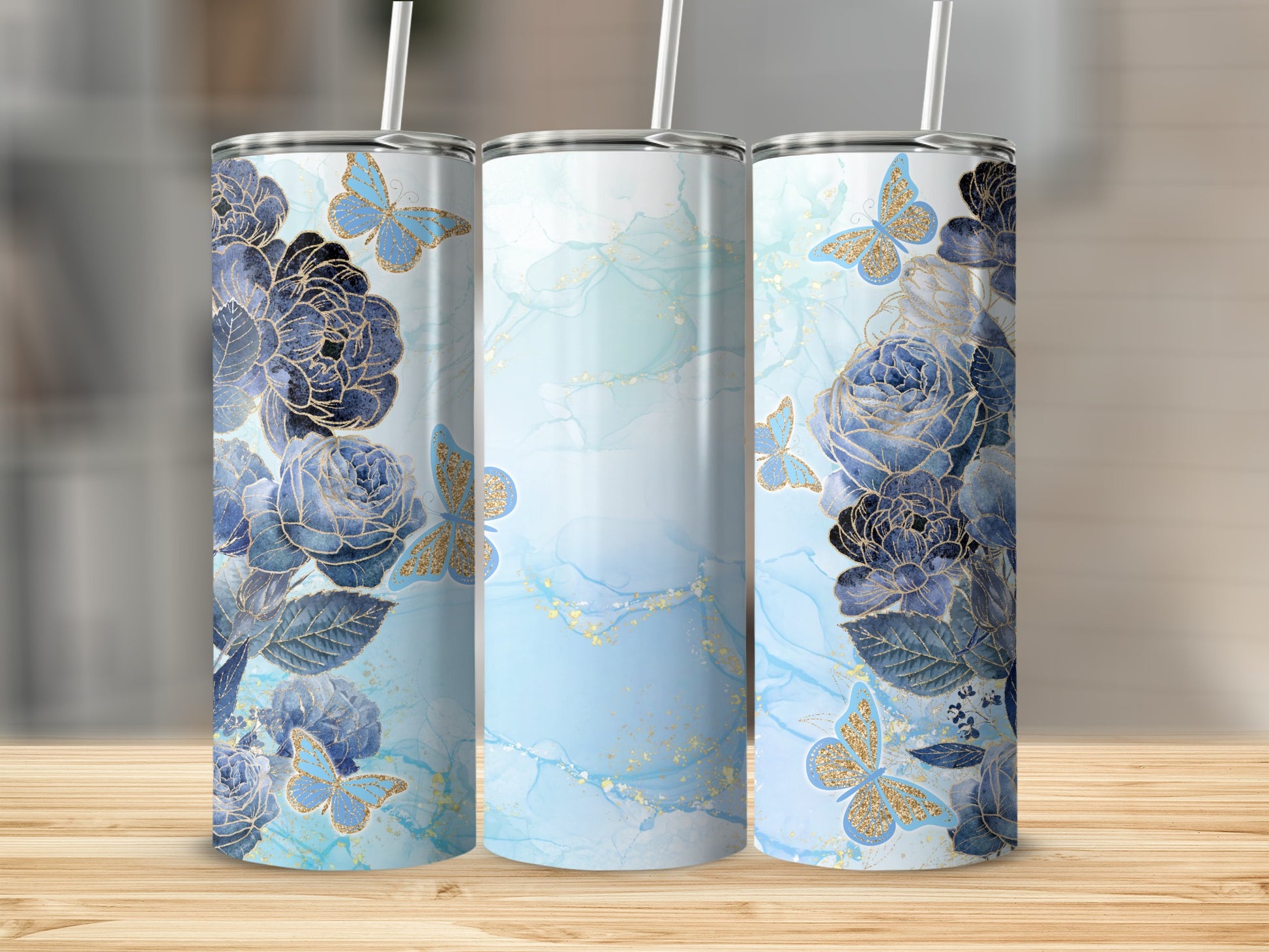 Blue floral pattern tumblers with gold butterflies and marble watercolor background.