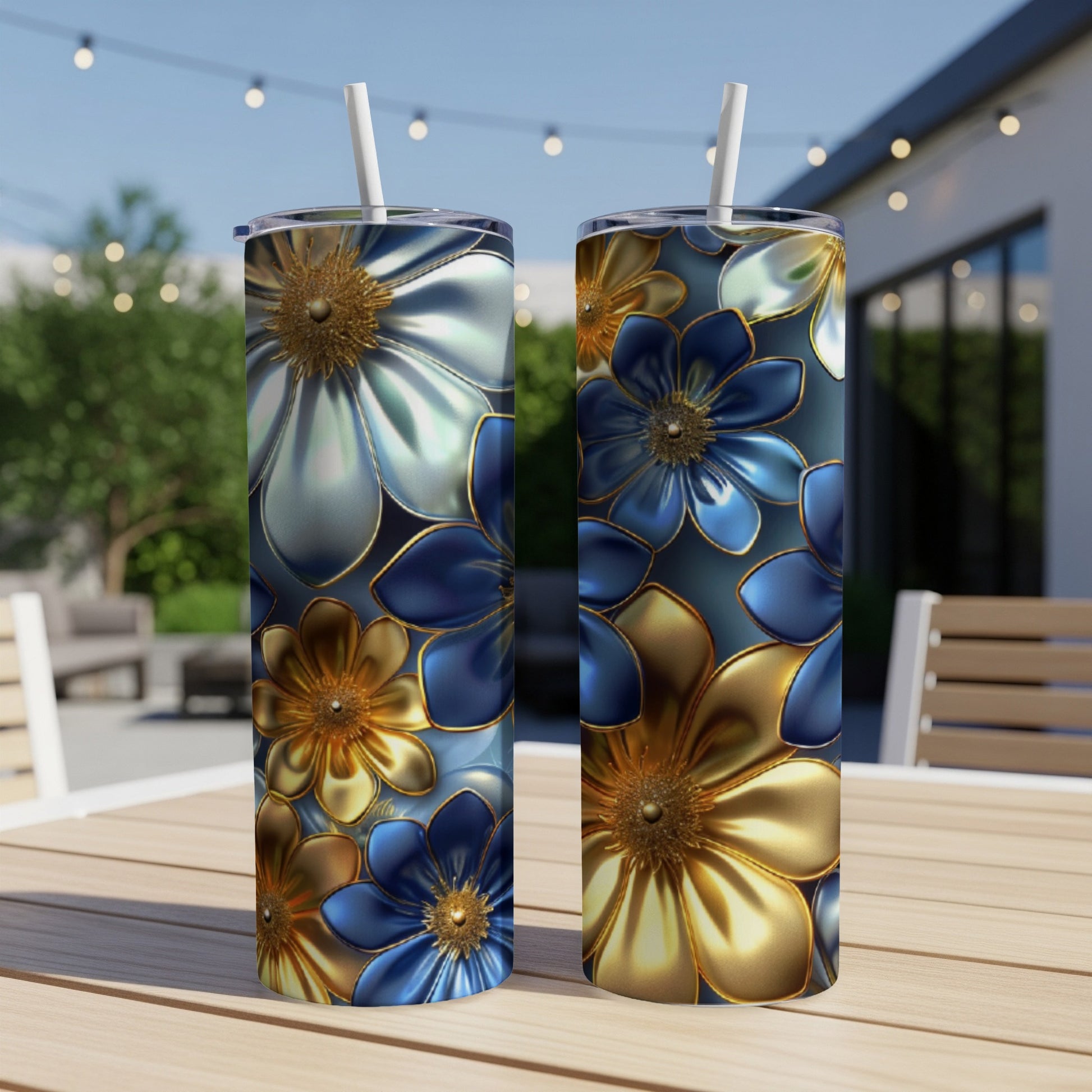 Two floral patterned tumblers with blue, gold, and silver flowers.
