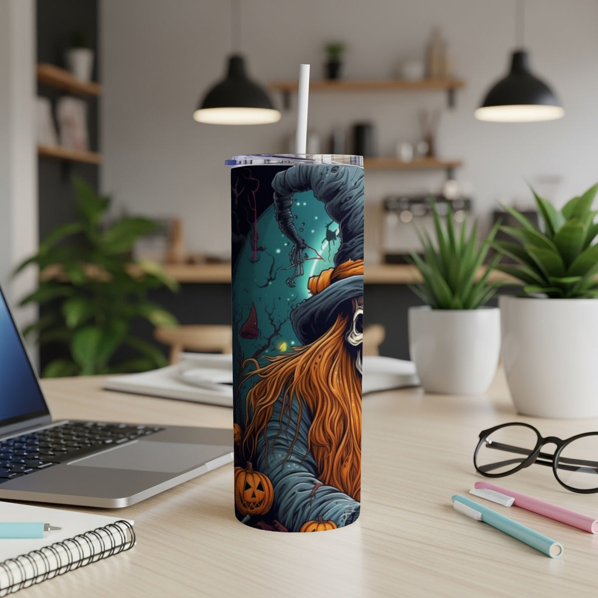 Tumbler with a spooky witch illustration and small pumpkins.