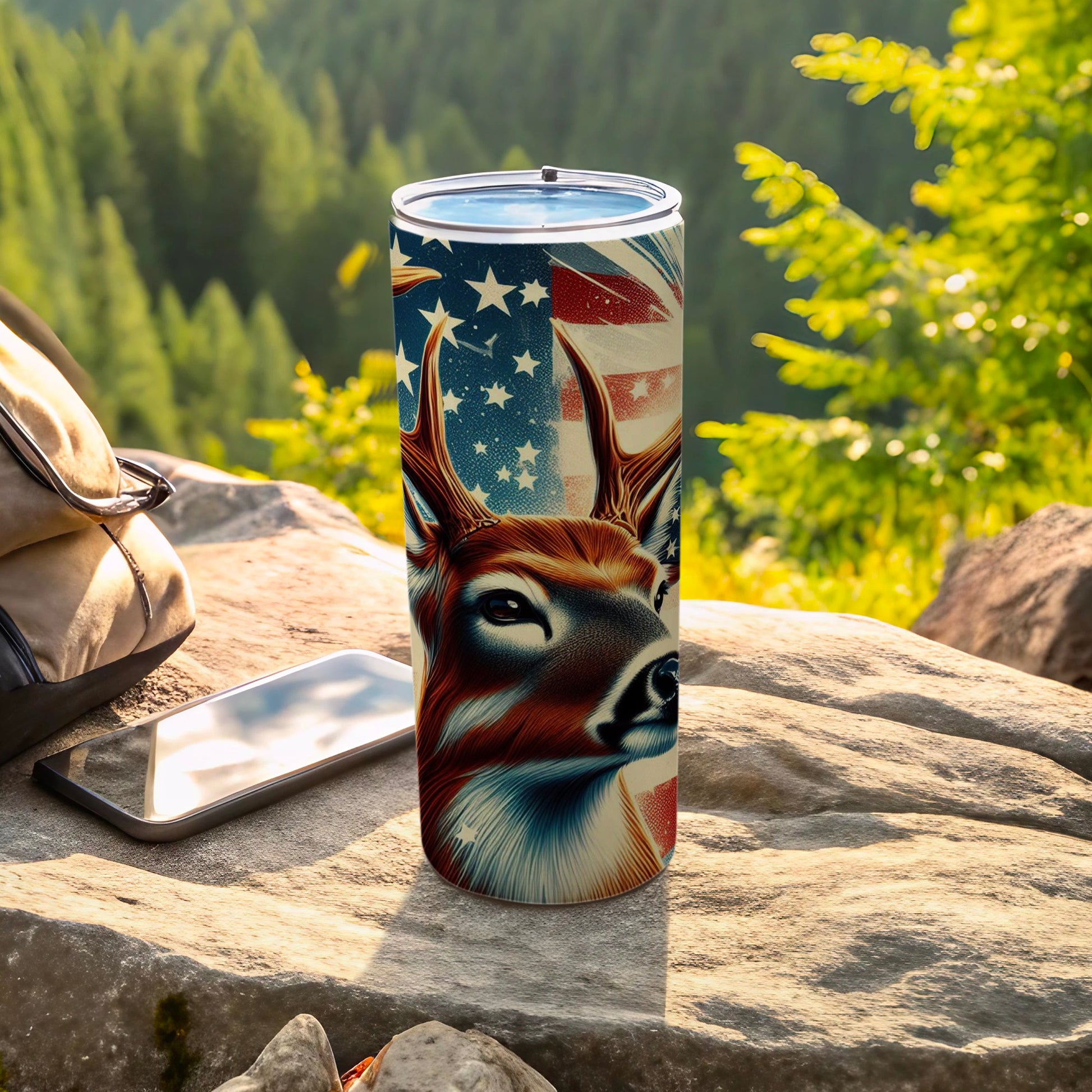 Deer and American flag design on a stainless steel tumbler.