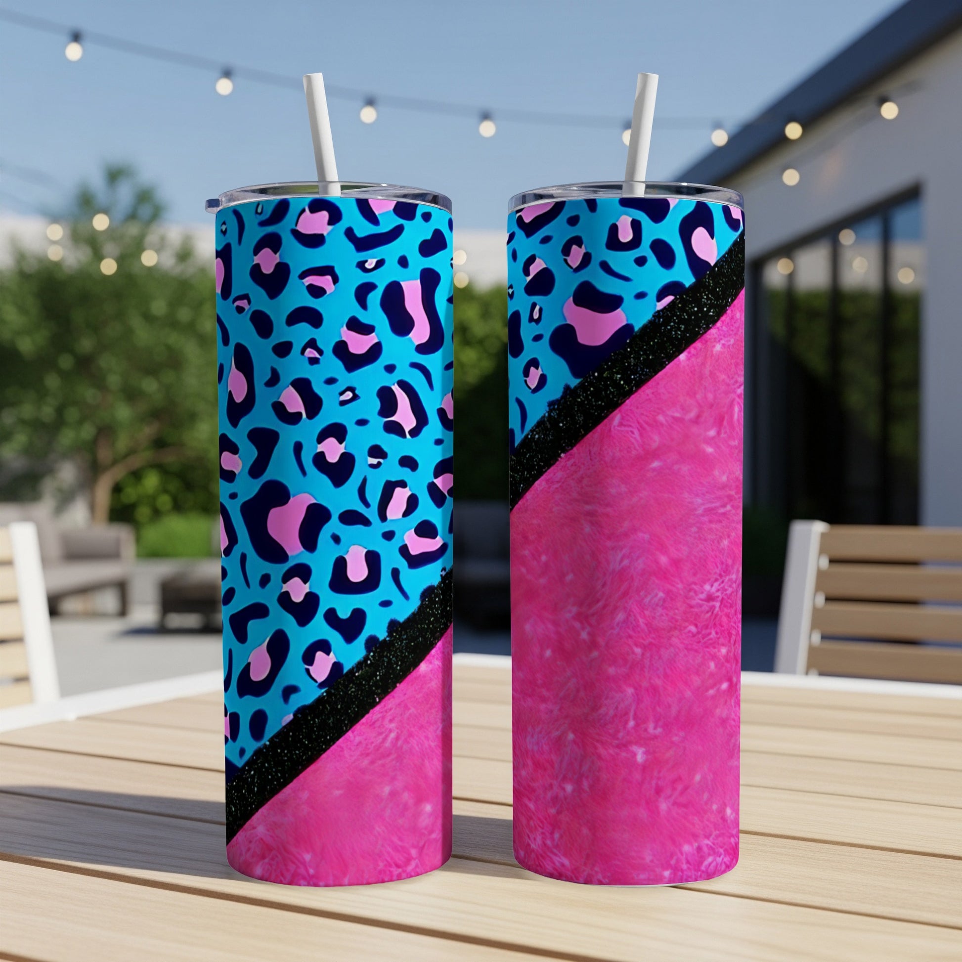 Two tumblers with leopard print and pink textured designs on a table.