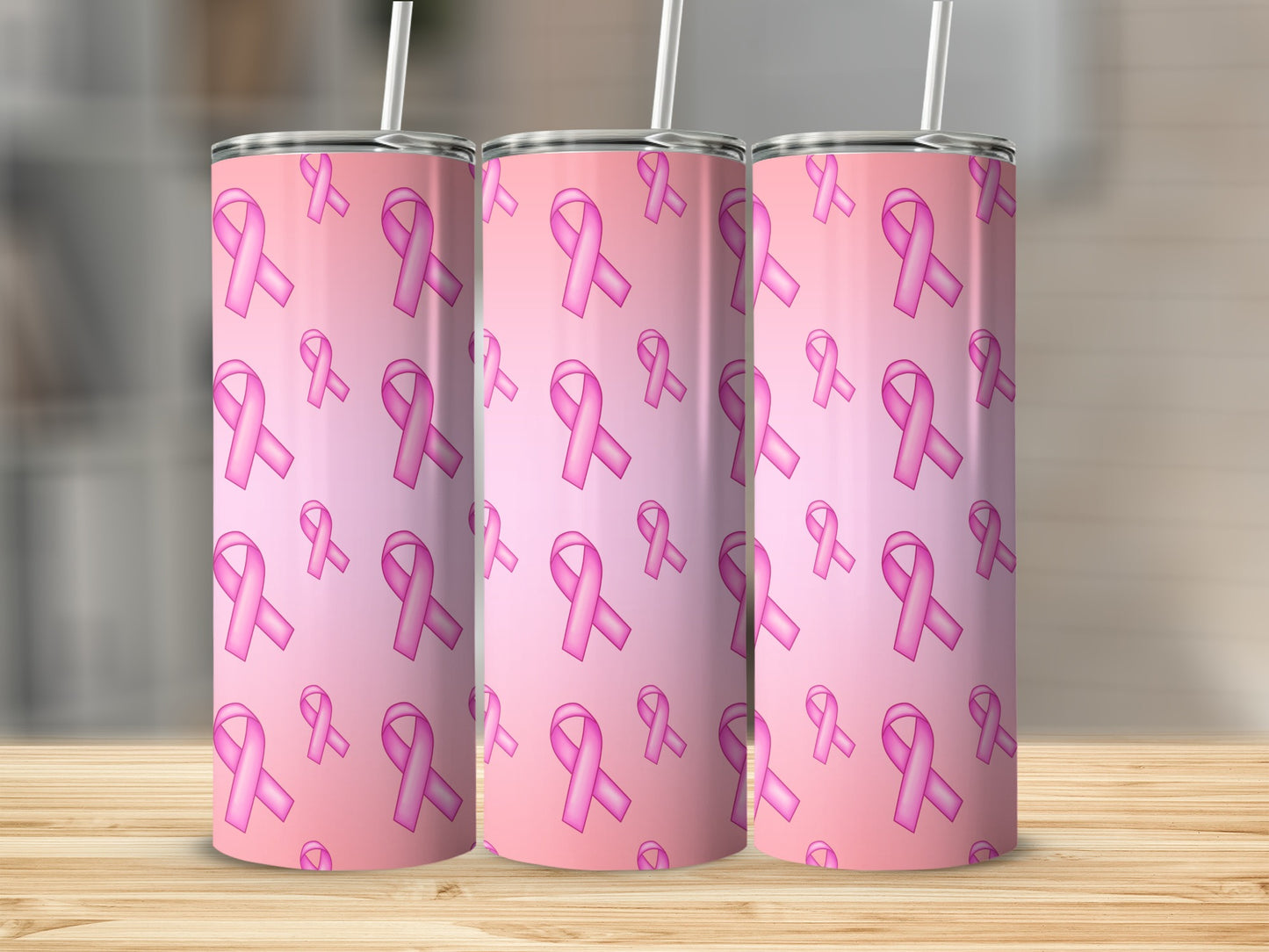 Pink breast cancer awareness ribbons pattern on three tumblers with straws.