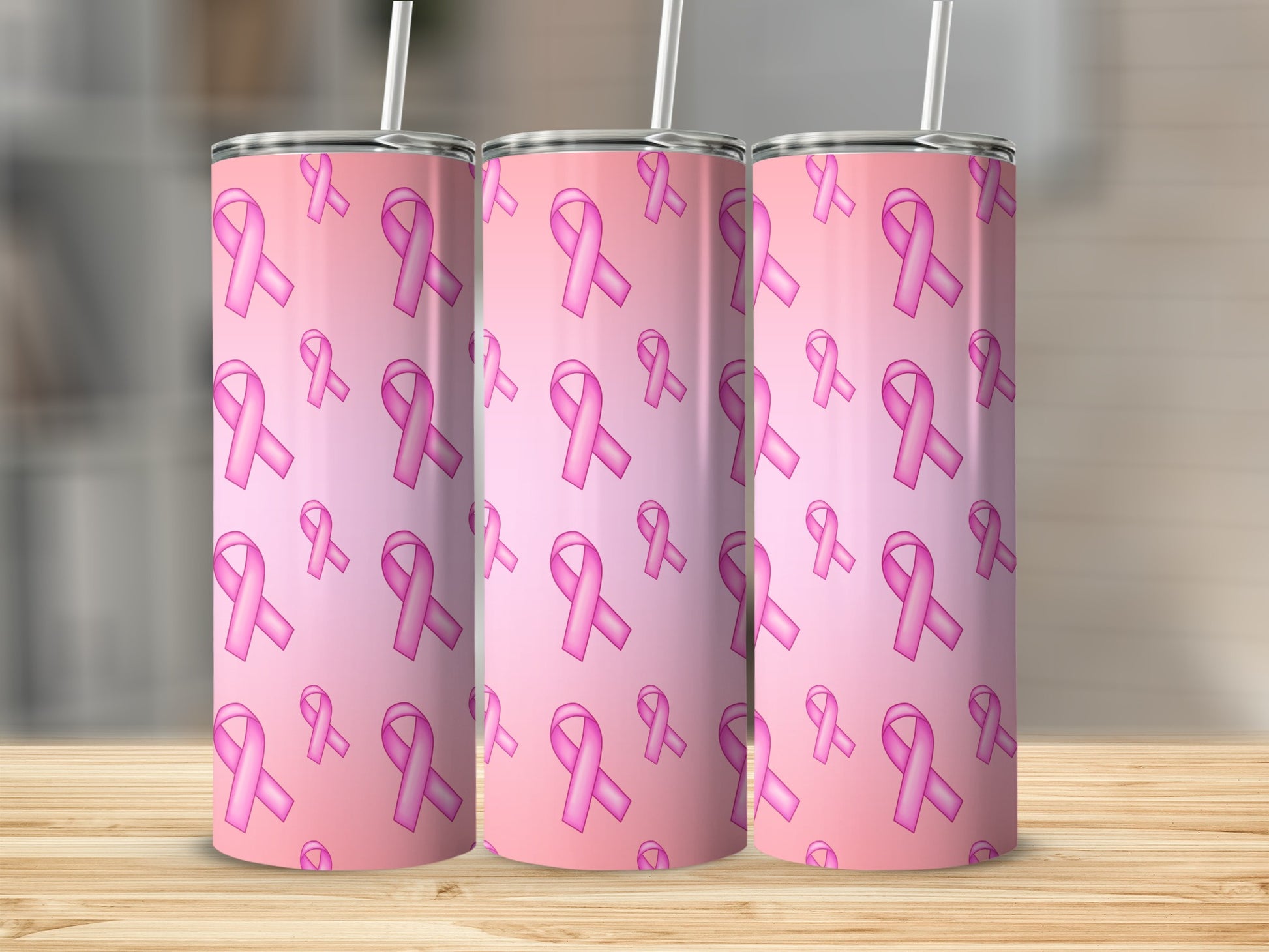 Pink breast cancer awareness ribbons pattern on three tumblers with straws.