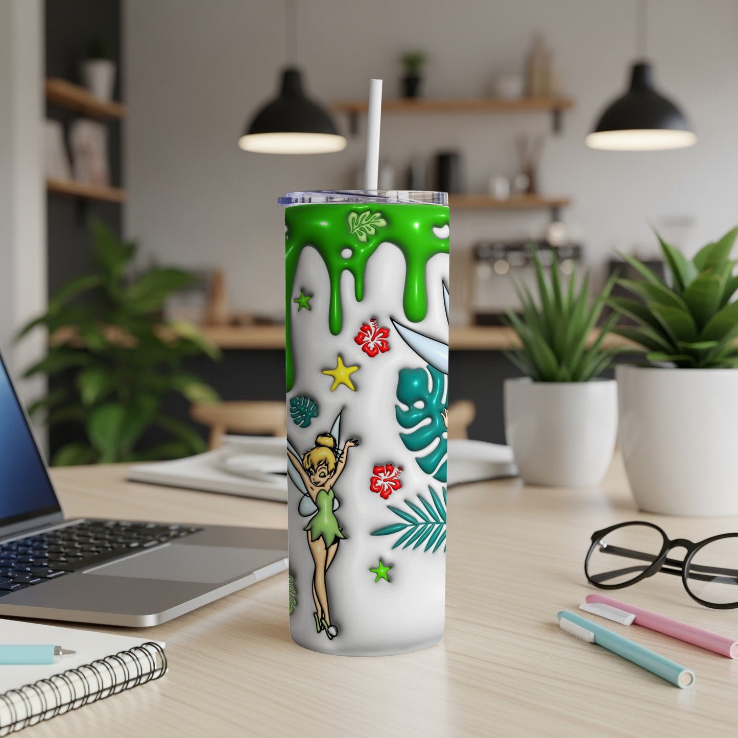Tinkerbell on a green-splattered white tumbler with tropical leaves and stars.
