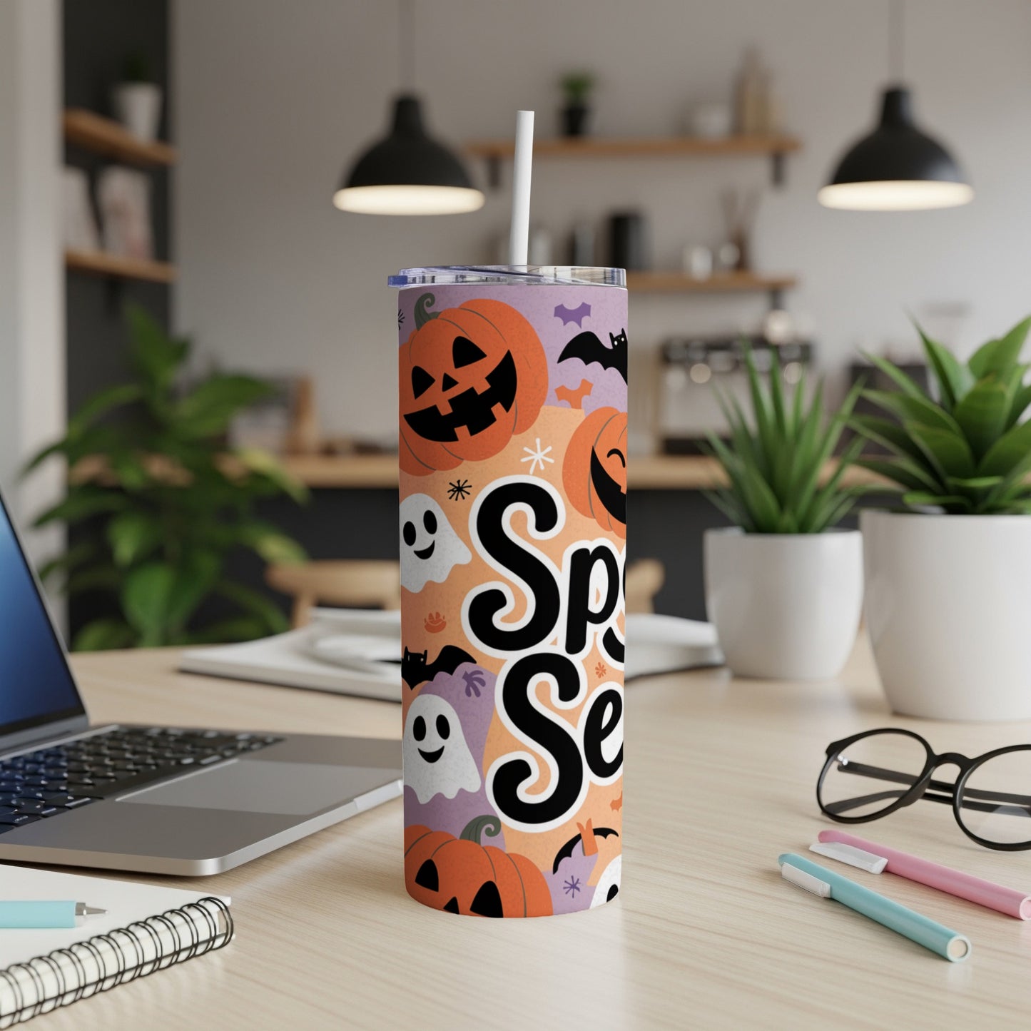 Spooky Season tumbler with pumpkins, ghosts, and bats on an orange and purple background.