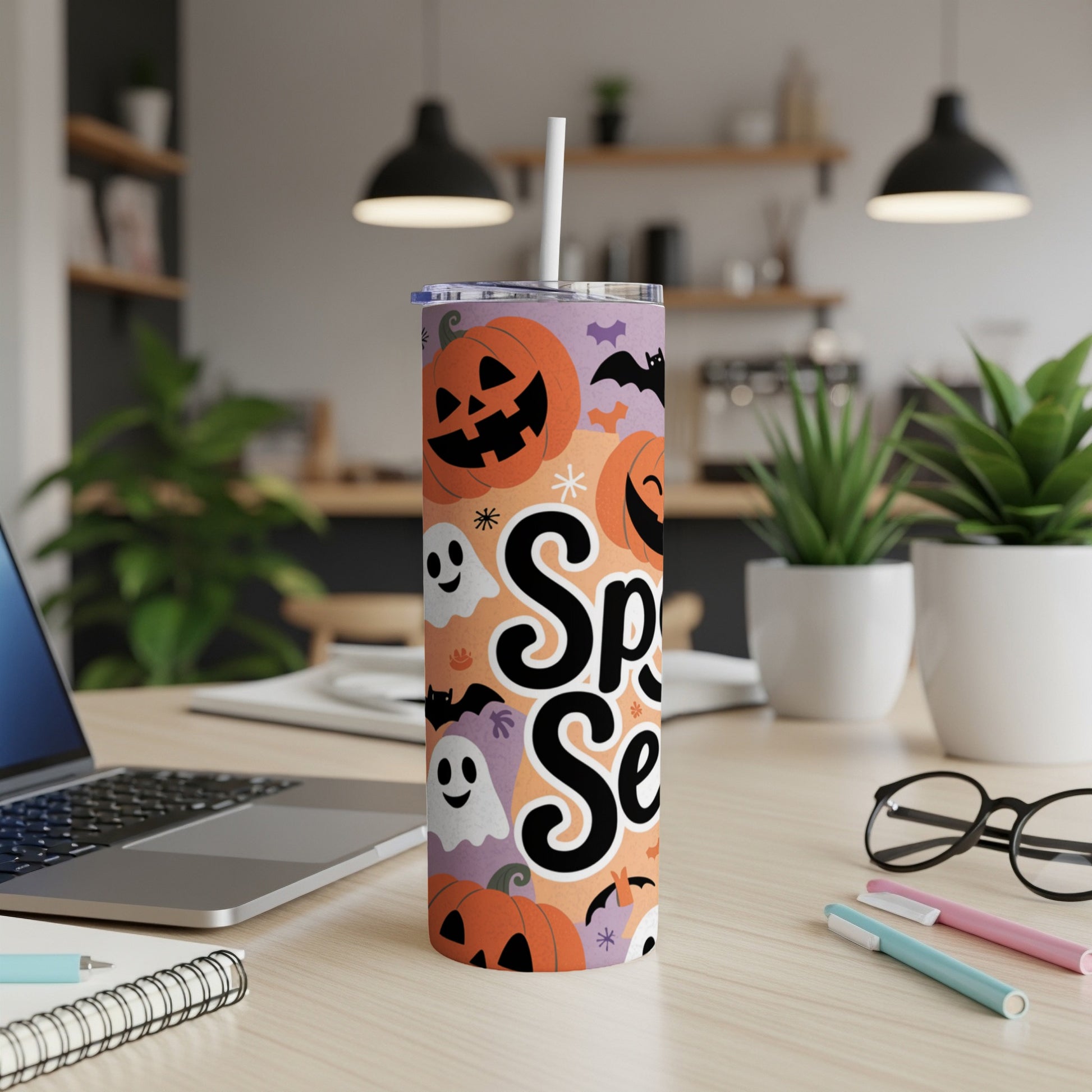 Spooky Season tumbler with pumpkins, ghosts, and bats on an orange and purple background.