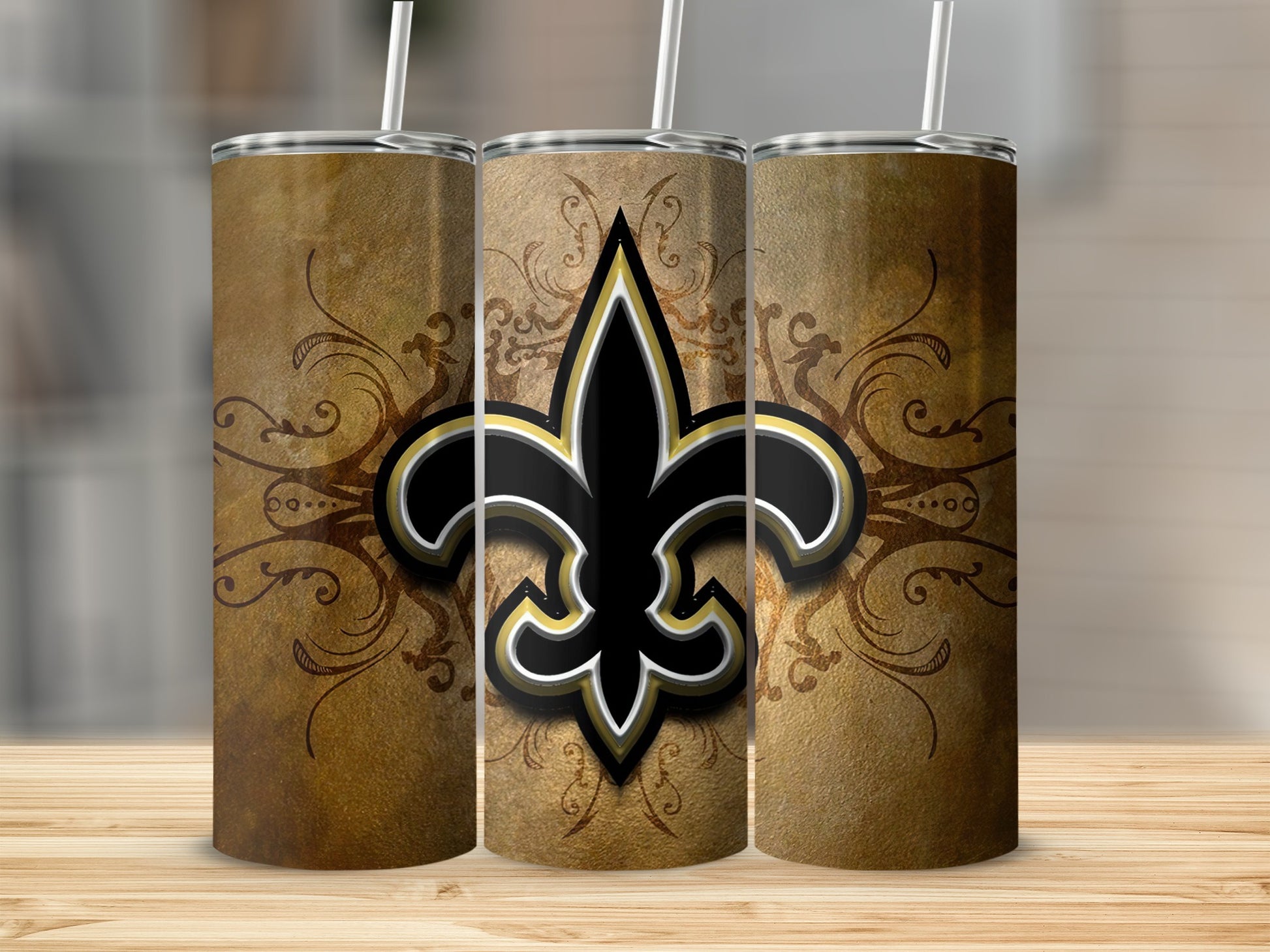 Three tumblers with a black, gold, and white fleur-de-lis on a vintage textured background.