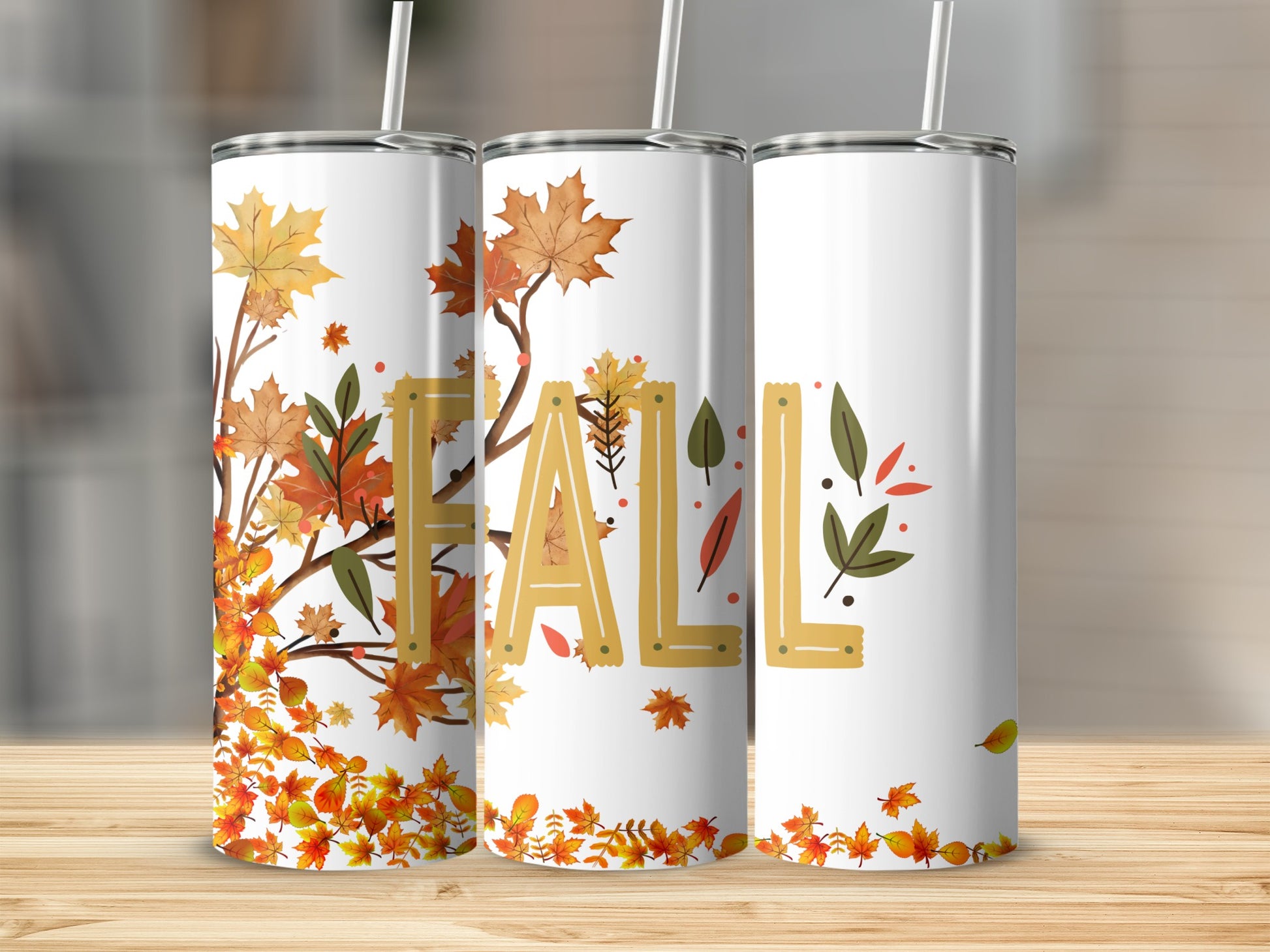Three white tumblers with fall leaf and "FALL" text designs.