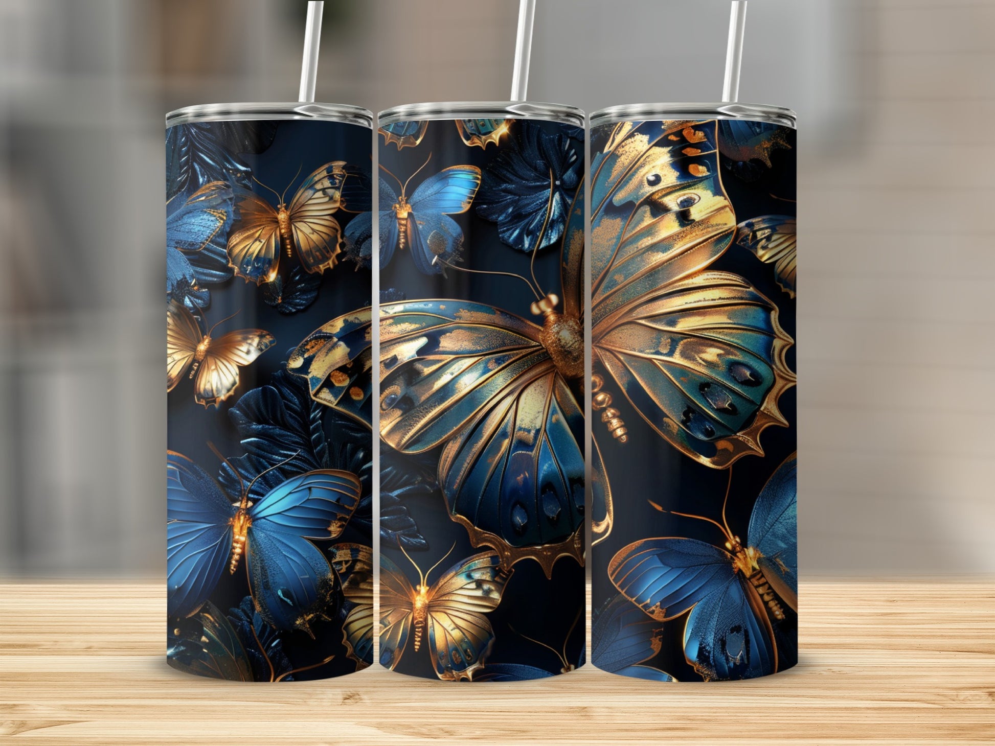 Three dark tumblers with blue and gold butterfly designs.