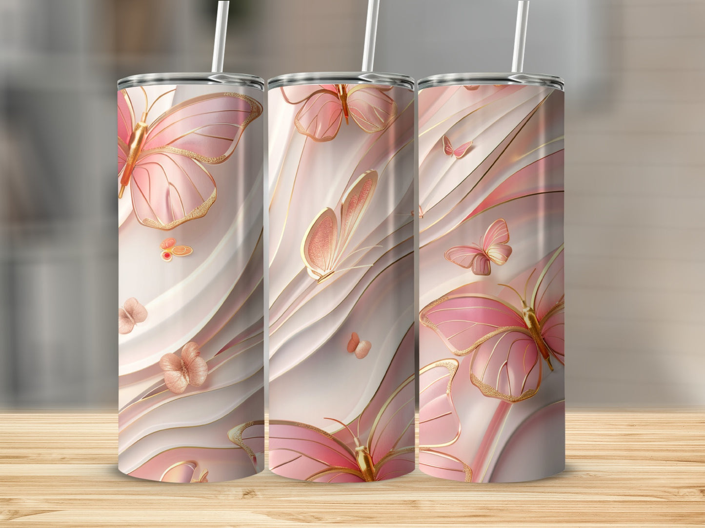 Three pink butterfly tumblers with gold accents and straws.