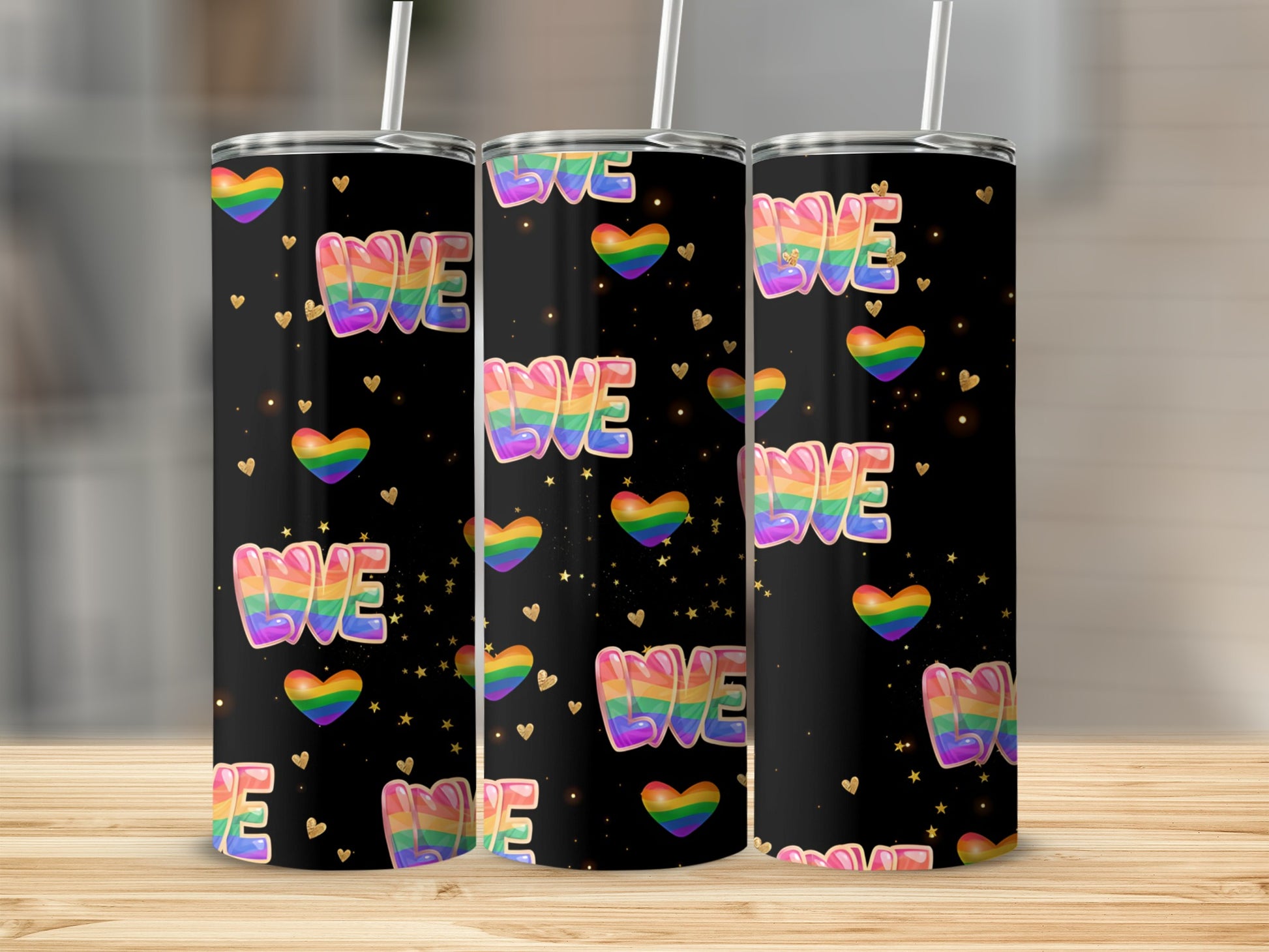 Rainbow "WE" hearts tumbler with gold sparkles on black background.