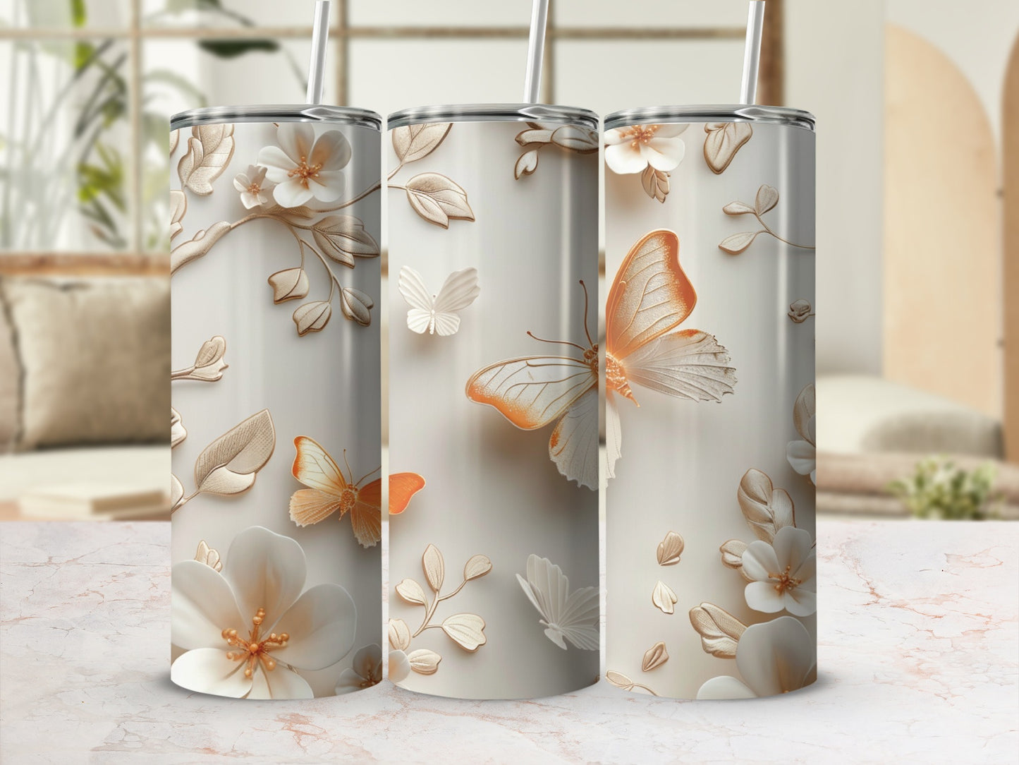 Three tumblers with embossed butterflies and floral designs.