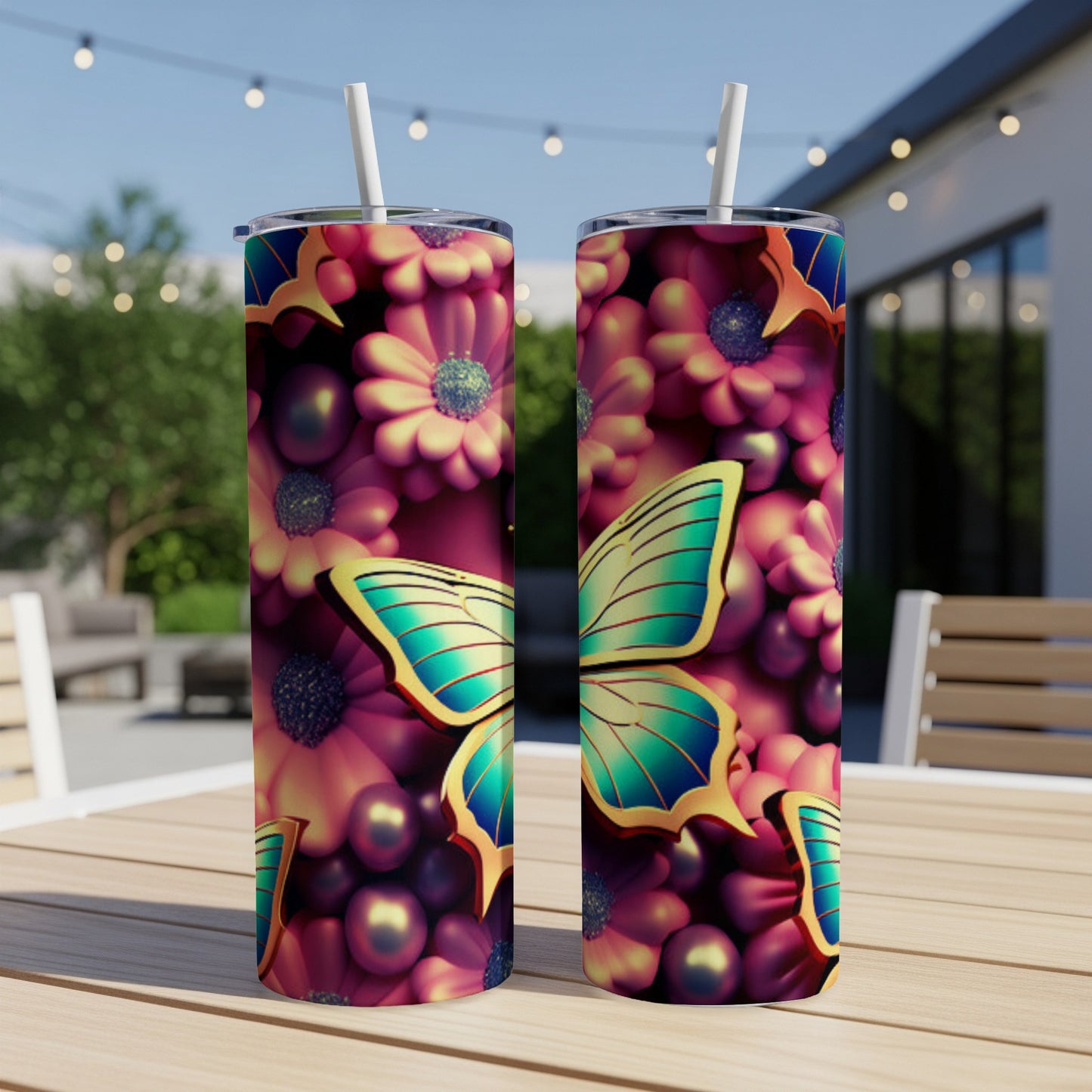Two tall tumblers with a floral and butterfly design sit on a table.